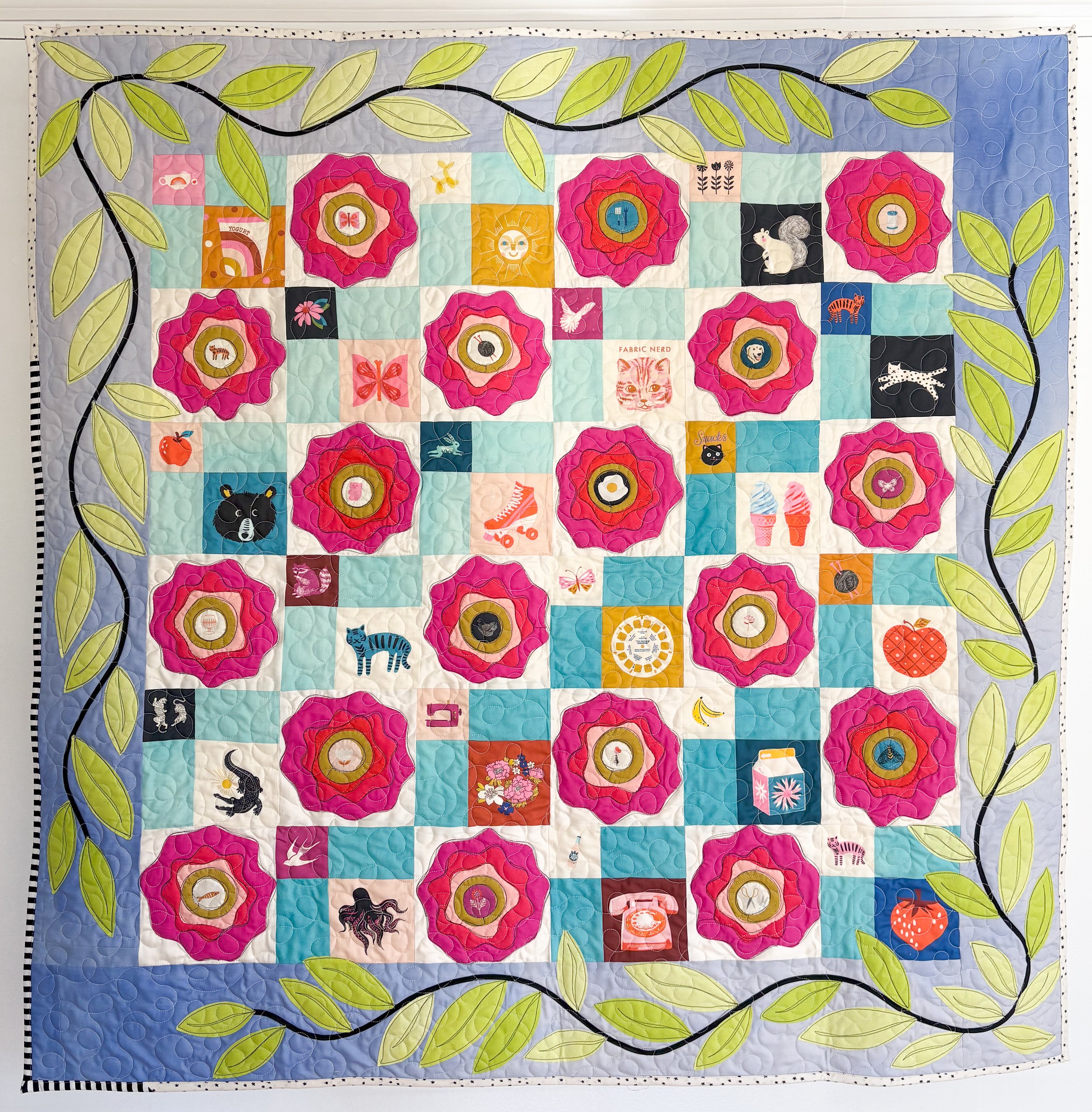 Magic Roses made by Tia Curtis. I am a huge fan of the Ruby Star Society. I love their fabric and as soon as I got my hands on their 10 years of magic panel I cut it up to make this quilt. I quilted it on my longarm.