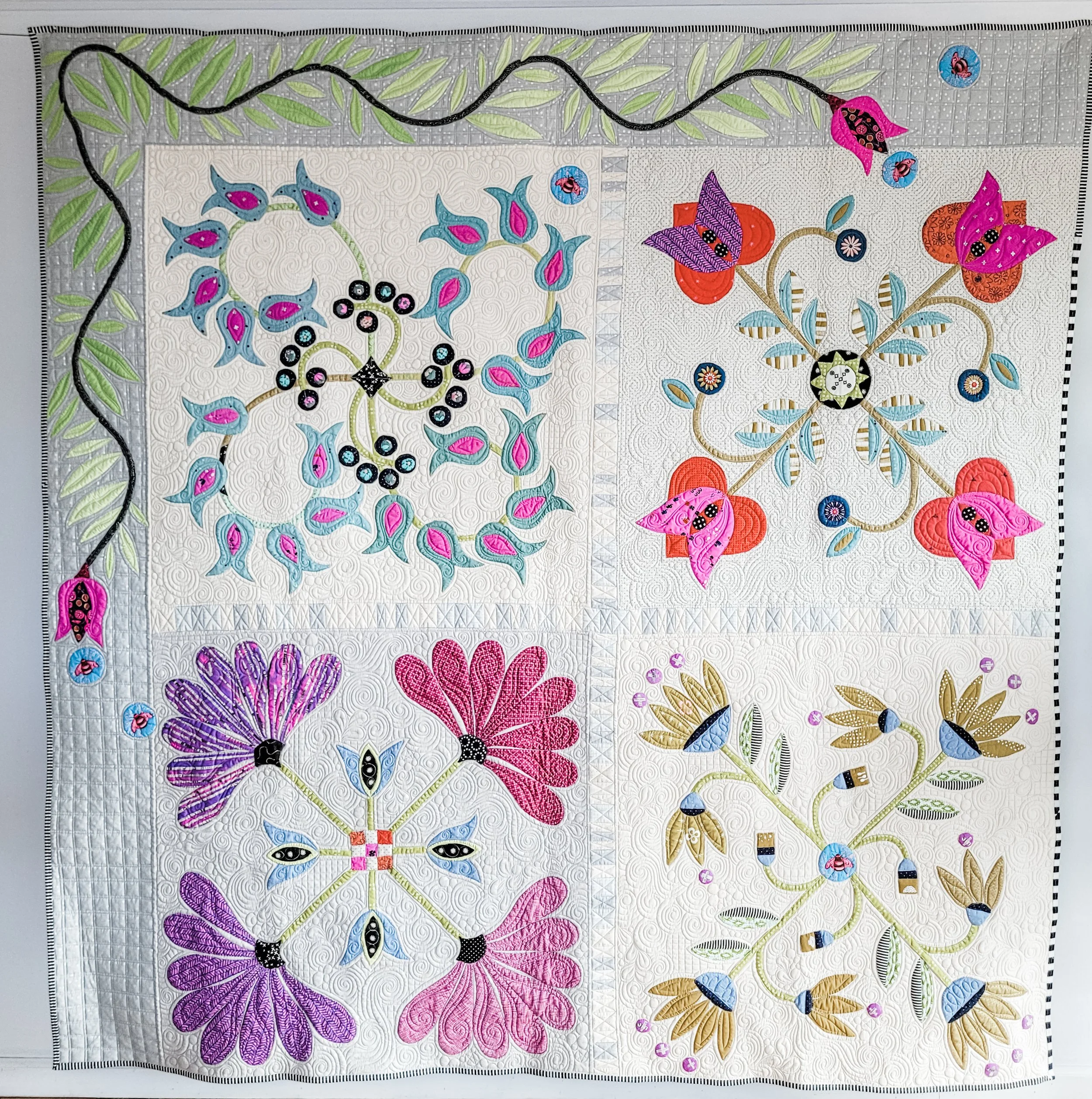 Emma's Garden by Tia Curtis. I am obsessed with 4 block applique. This is a massive quilt that combines 4 of my designs. I am writing patterns for all of my 4 block applique pieces.  I custom quilted it on my longarm.