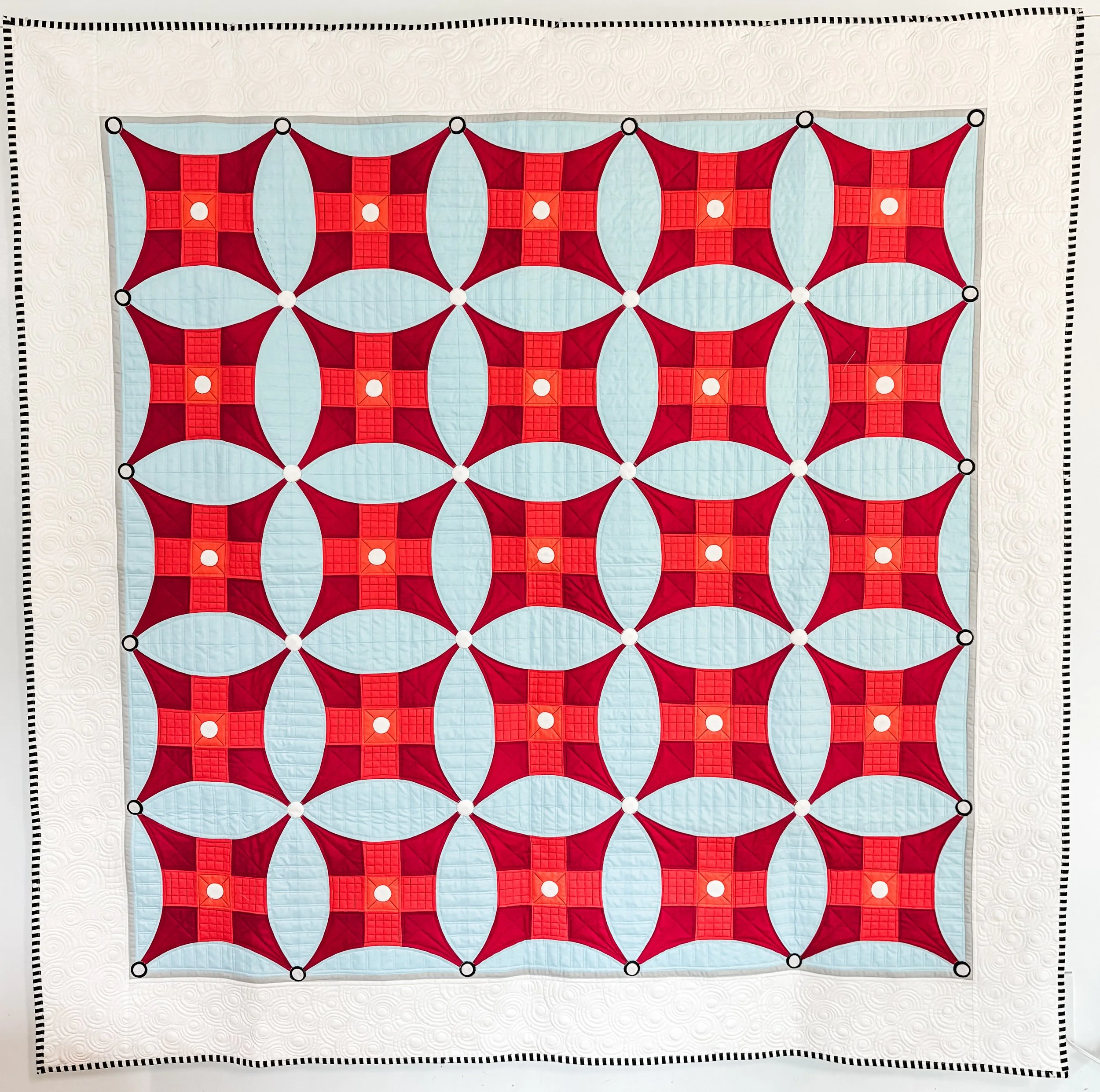 Happy Jumpers by Tia Curtis. I thought it would be fun to only use the fairly large scale improved 9 patch blocks in their own quilt. I custom quilted it on my long arm. This pattern will be released soon