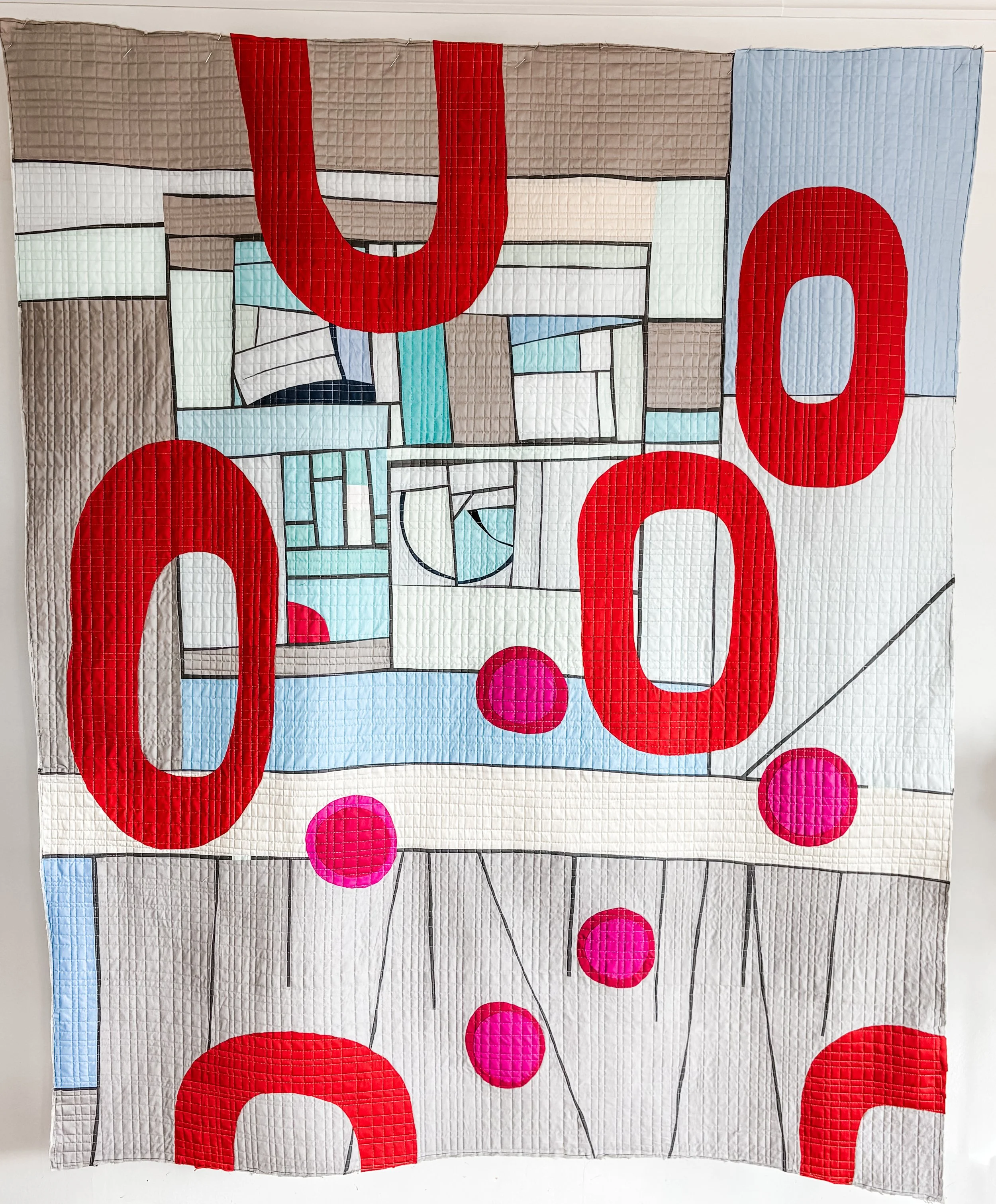 Intrusive thoughts made by Tia Curtis. This is another in my series of working with large scale applique on a pieced back. I quilted it on my longarm