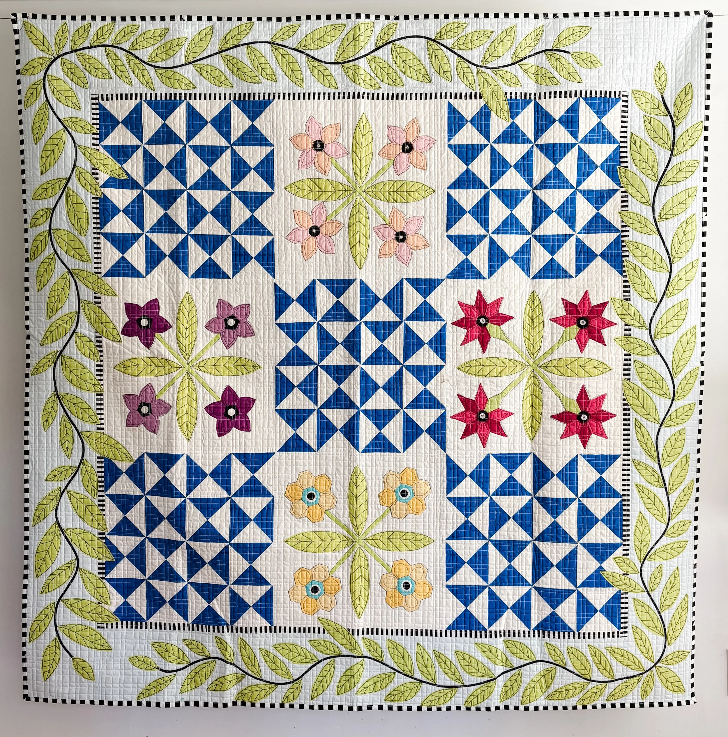 Laura's Garden 2 made by Tia Curtis. I had so much fun the first time I decided to make another version of this quilt. I wanted to add a big vine applique border. I custom quilted it on my longarm.
