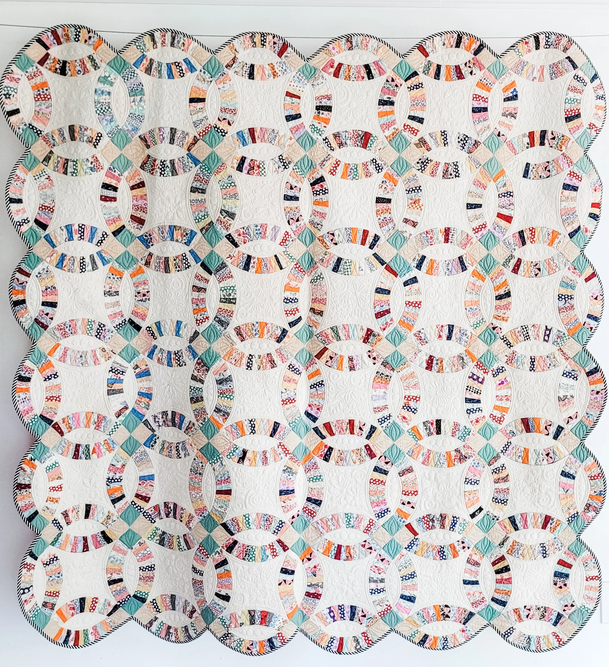 Double Wedding ring. Maker unknown. Quilted by Tia Curtis. I love a double wedding ring quilt but I am daunted by the idea of piecing one. I bought this top for $25 on ebay and had a blast custom quilting it on my longarm.