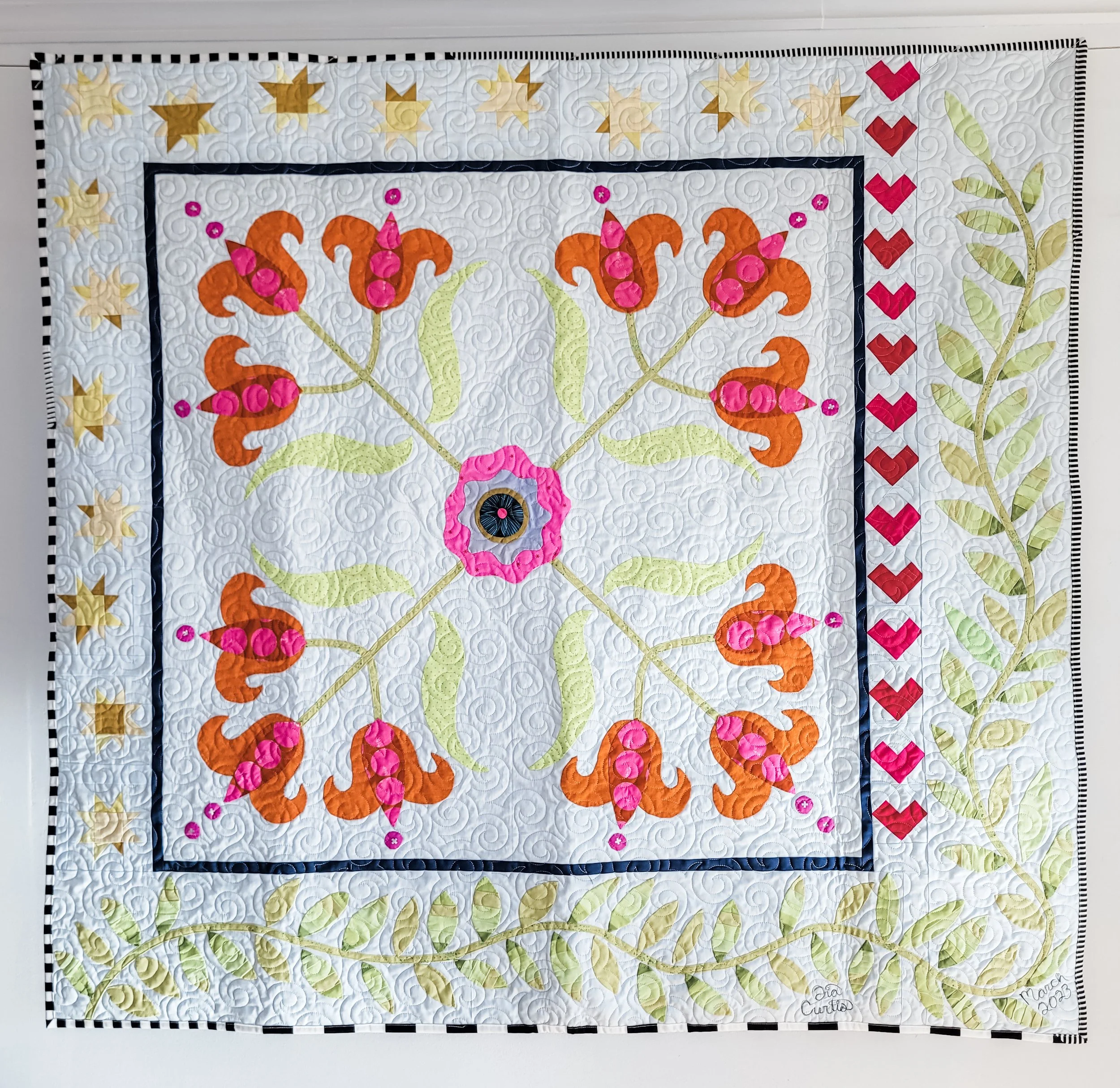 Lovely Lilies quilt styled in a medallion. Tia Curtis made this quilt with some of her solid scraps.