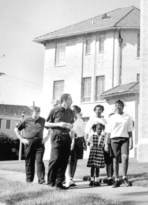 Fr. Tony Ricard and Fr. Harry Bugler walk with St. Rita school children around the church.