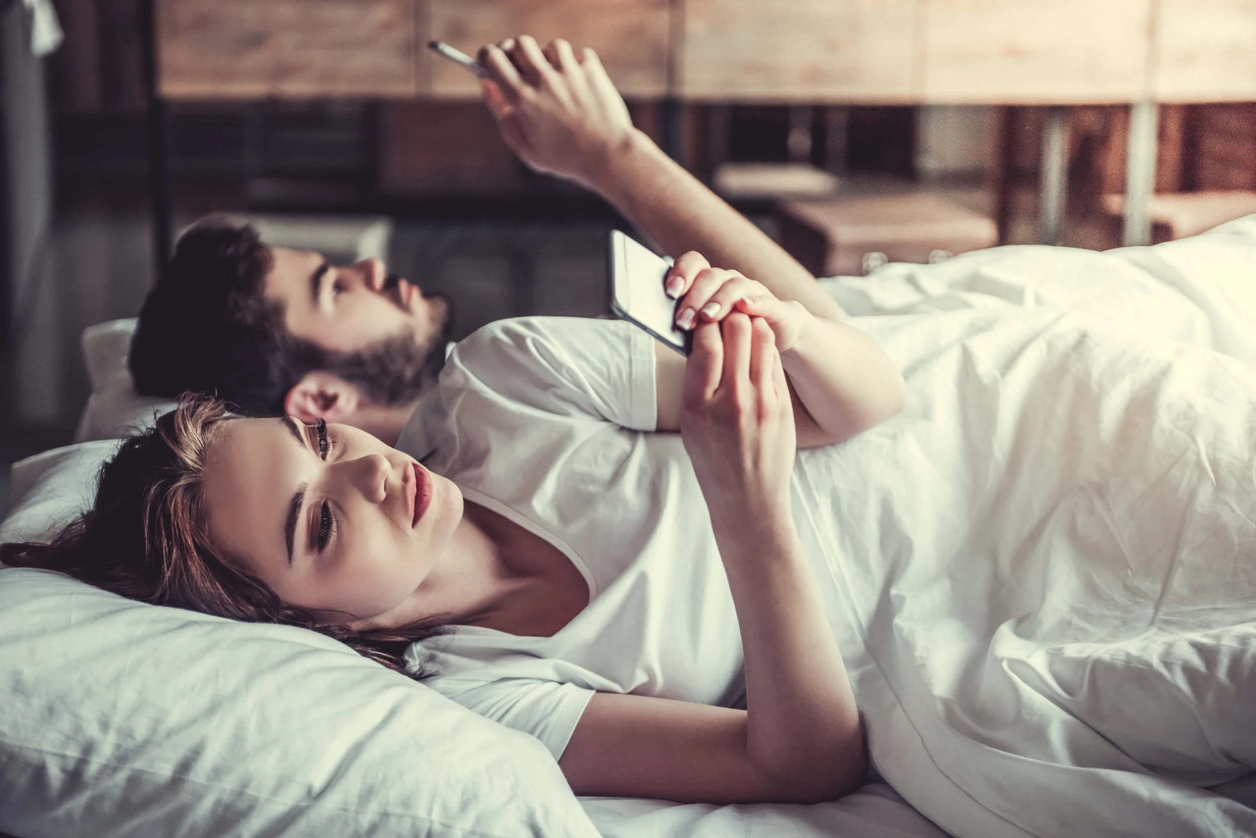 cell phone in bed.jpeg