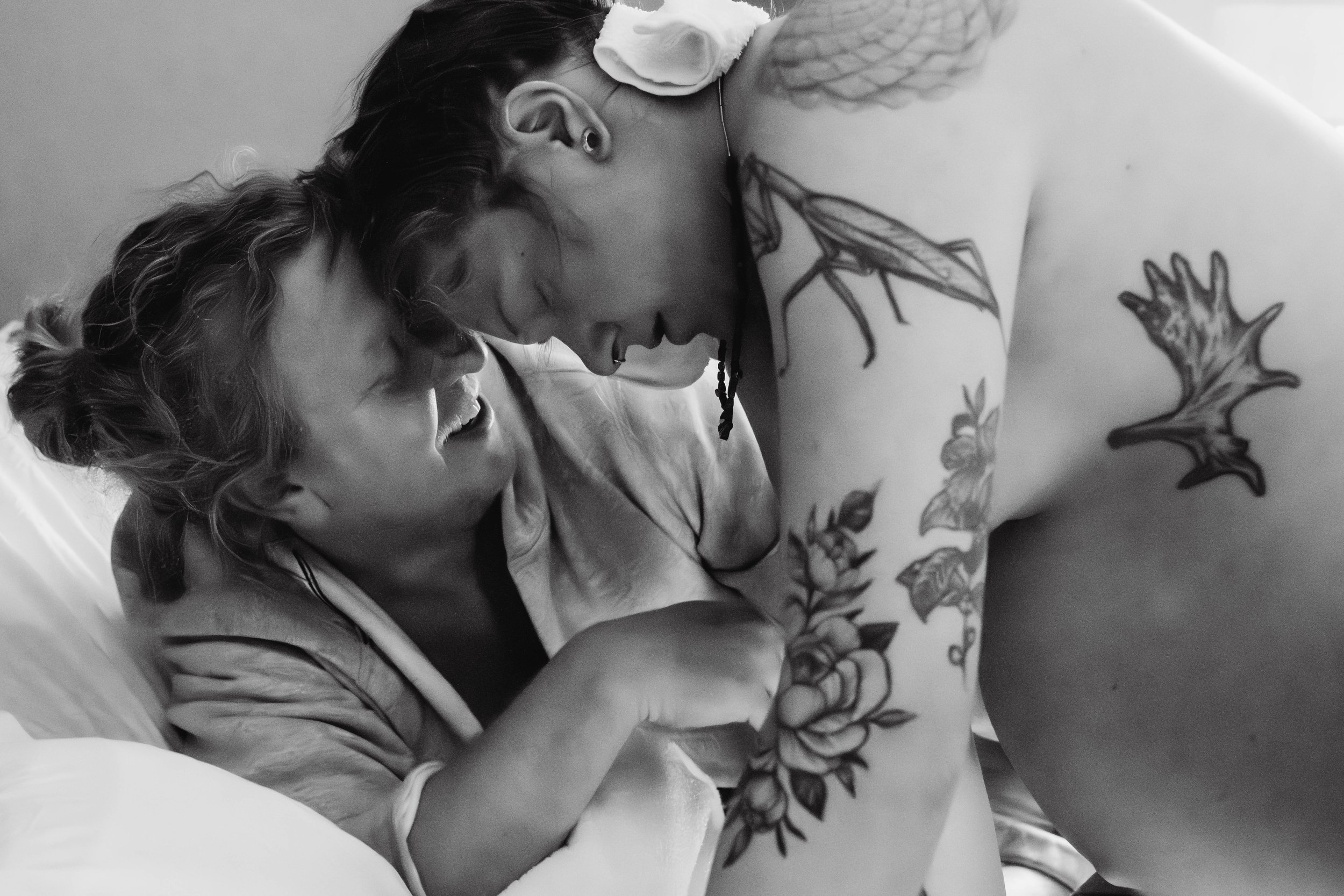 A woman in labor is supported by her husband while in between contractions at a birth center in Denvder.