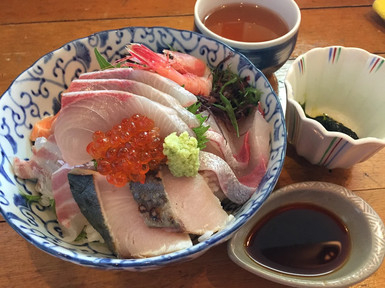 This is my go-to meal for fighting a cold. You can use any type of oily sashimi - salmon, salmon roe (pictured), mackerel, sardines, halibut (pictured), albacore tuna. This picture shows some red snapper too. The omega 3 from the fish is lubricating for the mucous membranes of the throat, anti-inflammatory and the protein content improves recovery from a virus. Depending on the thickness of the sashimi, adding raw fish to hot broth cooks it, so add it last minute as the goal is to have it as rare as possible. The second step is to chop up available spicy and pungeant veggies such as radish, daikon, watercress, mustard greens, arugula, radish, mustard or broccoli sprouts, broccolini, cabbage, nasturtium leaves/flowers, onions, leeks, ginger, garlic, hot peppers, jalapenos peppers, black pepper, white pepper and a big dollop of horseradish or japanese horseradish, known as wasabe (pictured). These veggies provide good clearing of mucous, as do all the peppery veggies. Plus they help to increase a fever, which deactivates a virus. Immune mushrooms such as shitake are also excellent in this soup for immune boosting properties. The spicier the better, as long as you can enjoy it. The last step is to pour the broth - I use whatever broth I have around - it could be the potassium broth , chicken broth, veggie broth or dashi . Ingredients: Serves 1 (needs to be prepared fresh each time, as cooked veggies lose their mucous fighting properties) 1 cups of your favorite home-made stock 1/2 pound of the freshest sushi grade oily fish you can get (from a fish market, or sushi takeout restaurant) 1/4 cup fresh shitake mushrooms, or reconstituted dried ones- finely chopped 1/3 cup chopped watercress 1/2 tsp finely chopped chili pepper (if not avoiding nightshades) 1 T chopped Scallions 1 teaspoon of finely chopped ginger 1/2 tsp of wasabi or horseradish 1 lemon wedge 1 T chopped cilantro Other vegetables (radish, daikon, chopped garlic, etc) Directions: Bring broth to a simmer point Add veggies and fish to the bowl Ladle enough broth to cover the fish and veggies. Garnish with cilantro, wasabi and a fresh squeeze of lemon Eat immediately, and repeatedly.