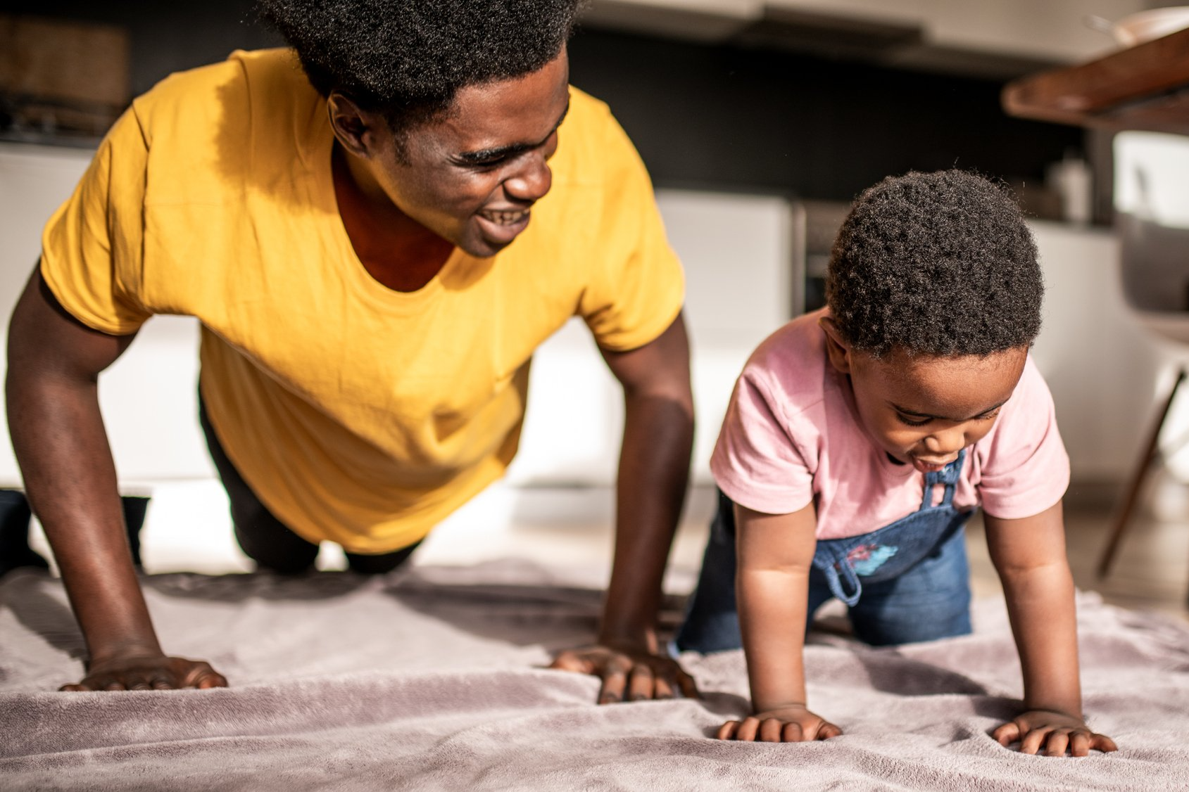 Dad doing push ups with toddler 4.18.21.png