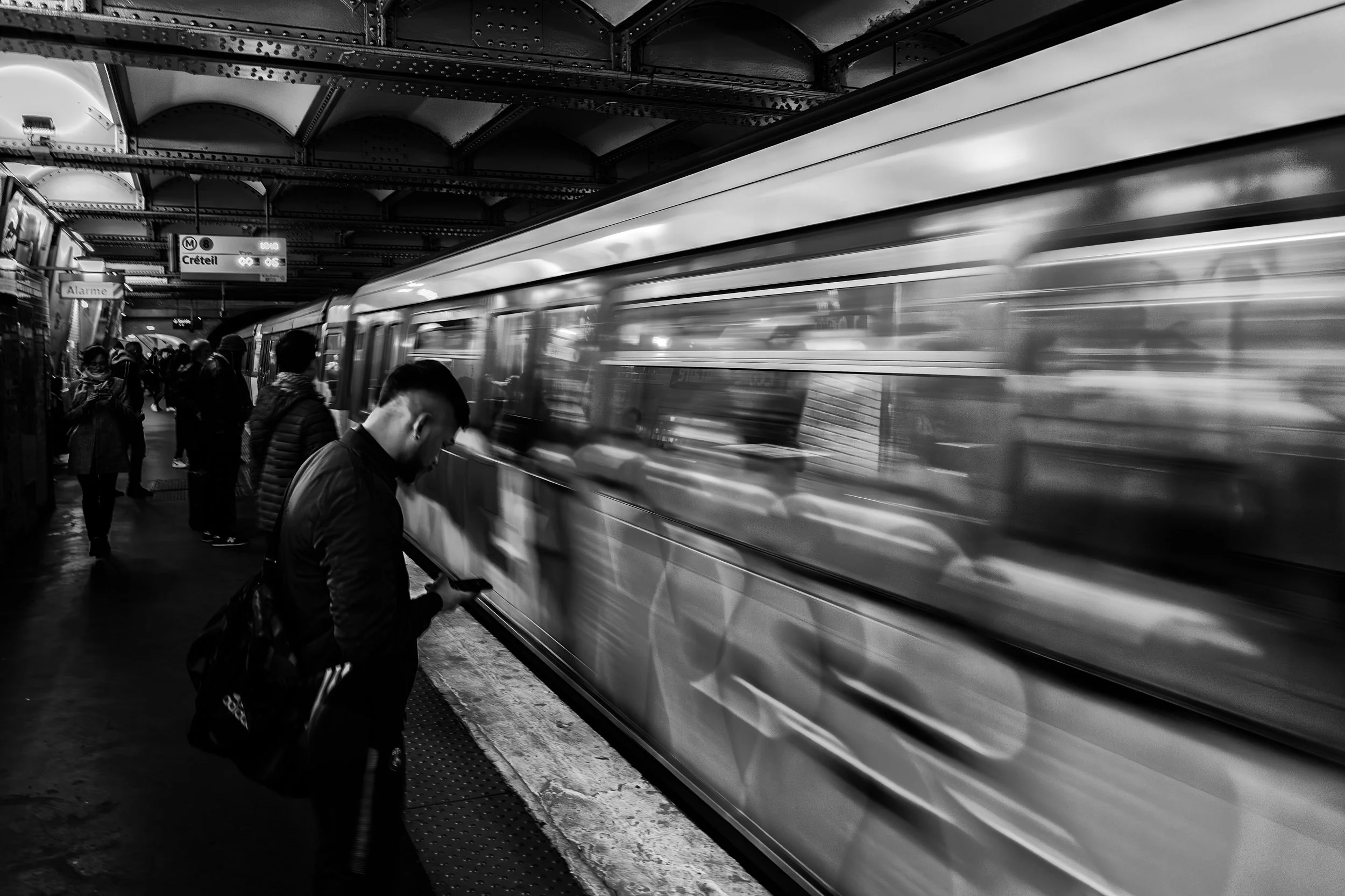 Paris Metro, France

 

  A Paris Metro train moves through a Line 8 platform while passengers wait nearby. The scene belongs to the everyday transit system that carries people across Paris and its surrounding suburbs. 