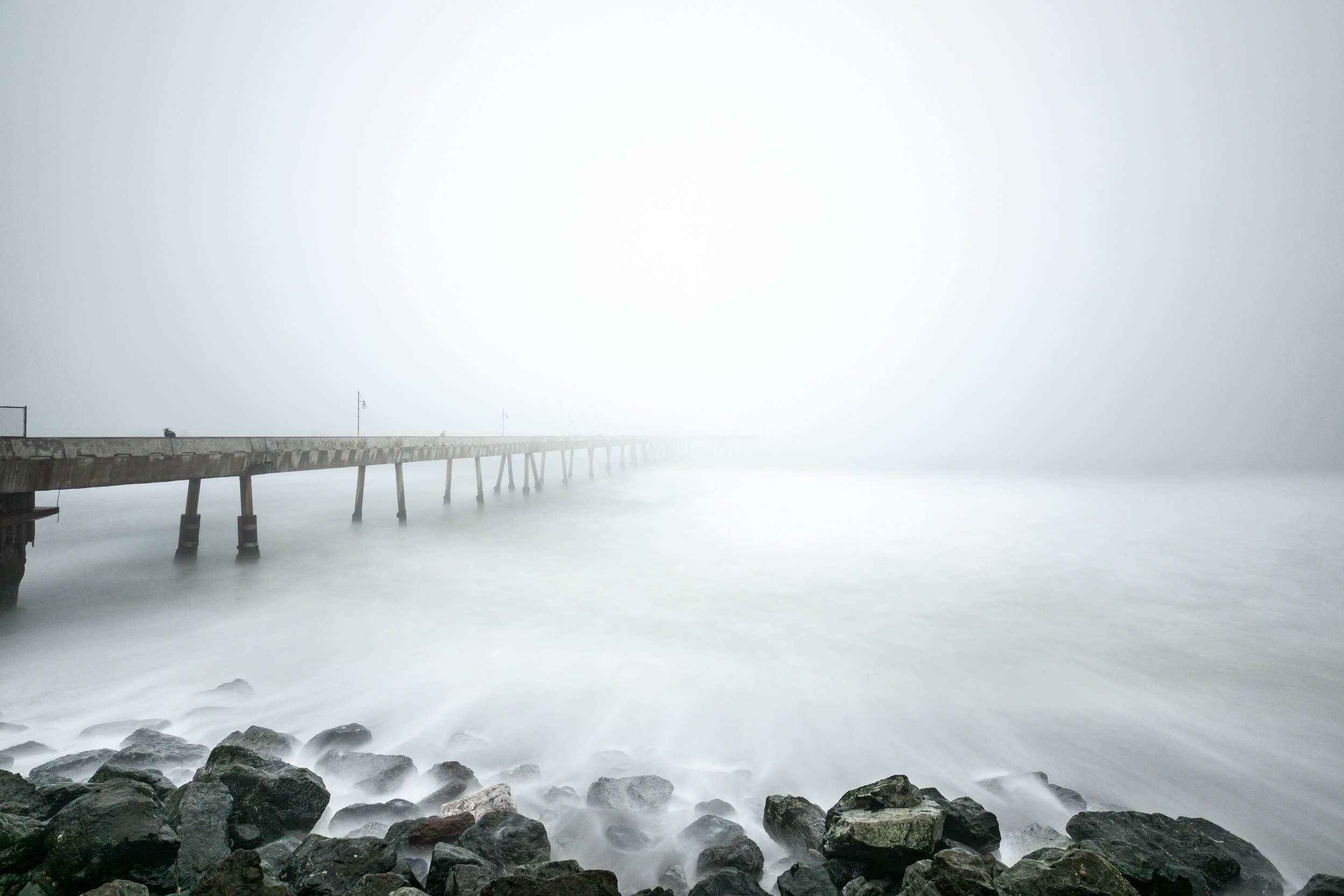 Lines Through the Fog

 

 Pacifica Municipal Pier extends into the Pacific Ocean along the coast of Pacifica, California. Dense marine fog often shapes the visual character of this part of the San Mateo County shoreline.
 