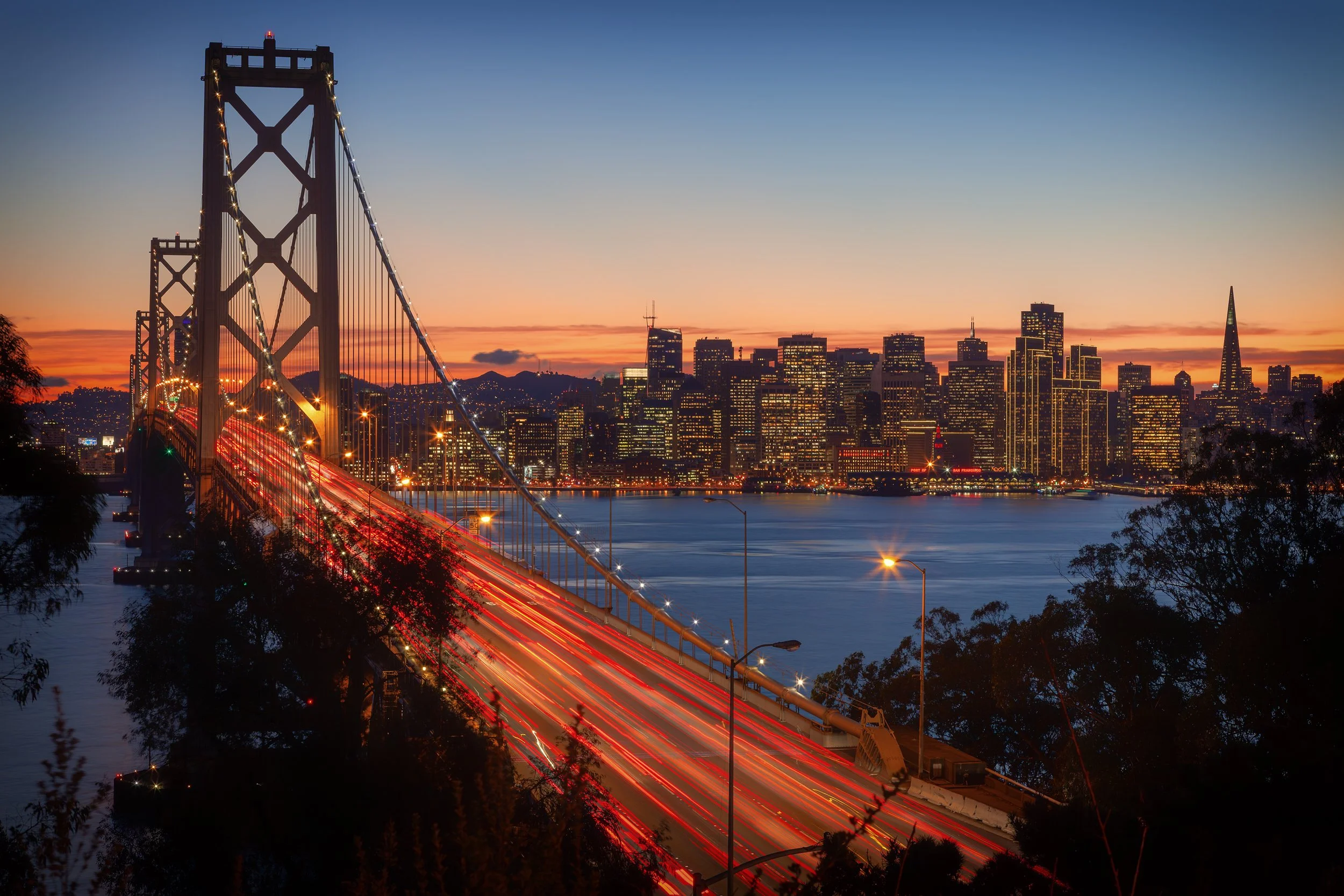 Bay Lights at Dusk

 

 The western span of the San Francisco–Oakland Bay Bridge carries traffic into the city as the downtown skyline rises beyond the water. The bridge is one of the defining transportation landmarks of the San Francisco Bay Area. 