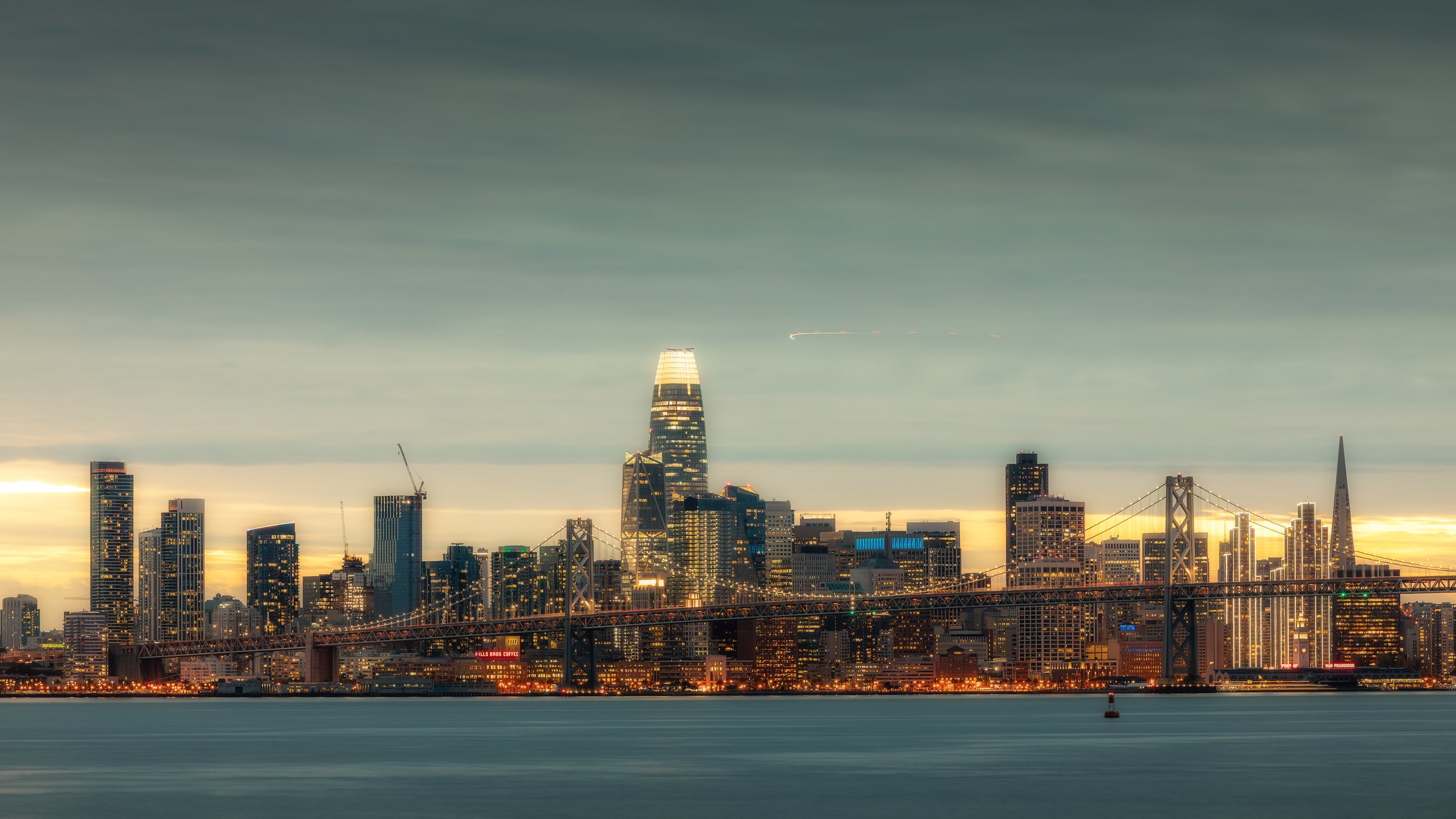 Bay Bridge at Golden Hour

 

 The San Francisco skyline stands behind the San Francisco-Oakland Bay Bridge at golden hour. The view includes downtown towers and the bridge corridor linking San Francisco with the East Bay. 