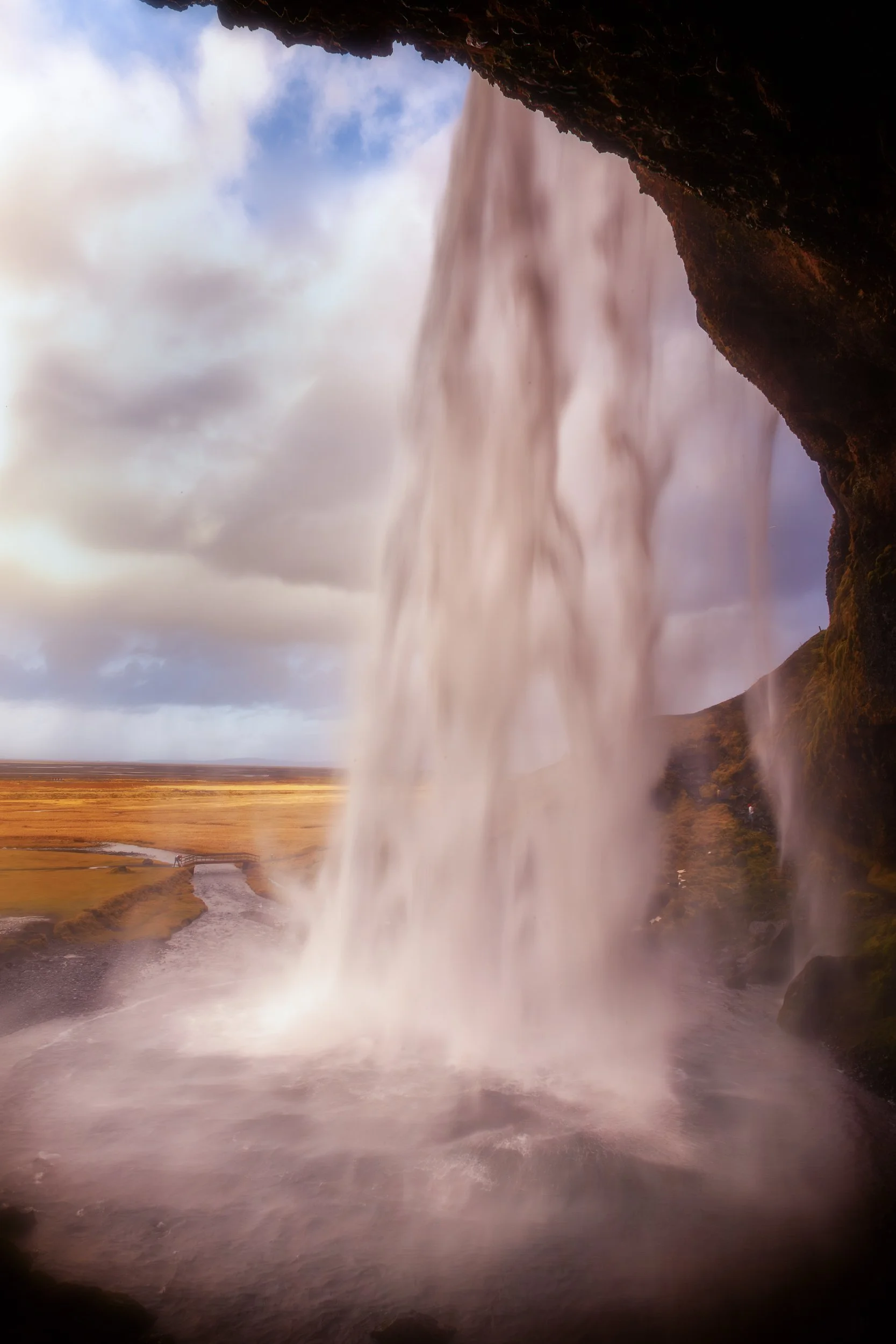 View from behind Seljalandsfoss waterfall on Iceland's South Coast.