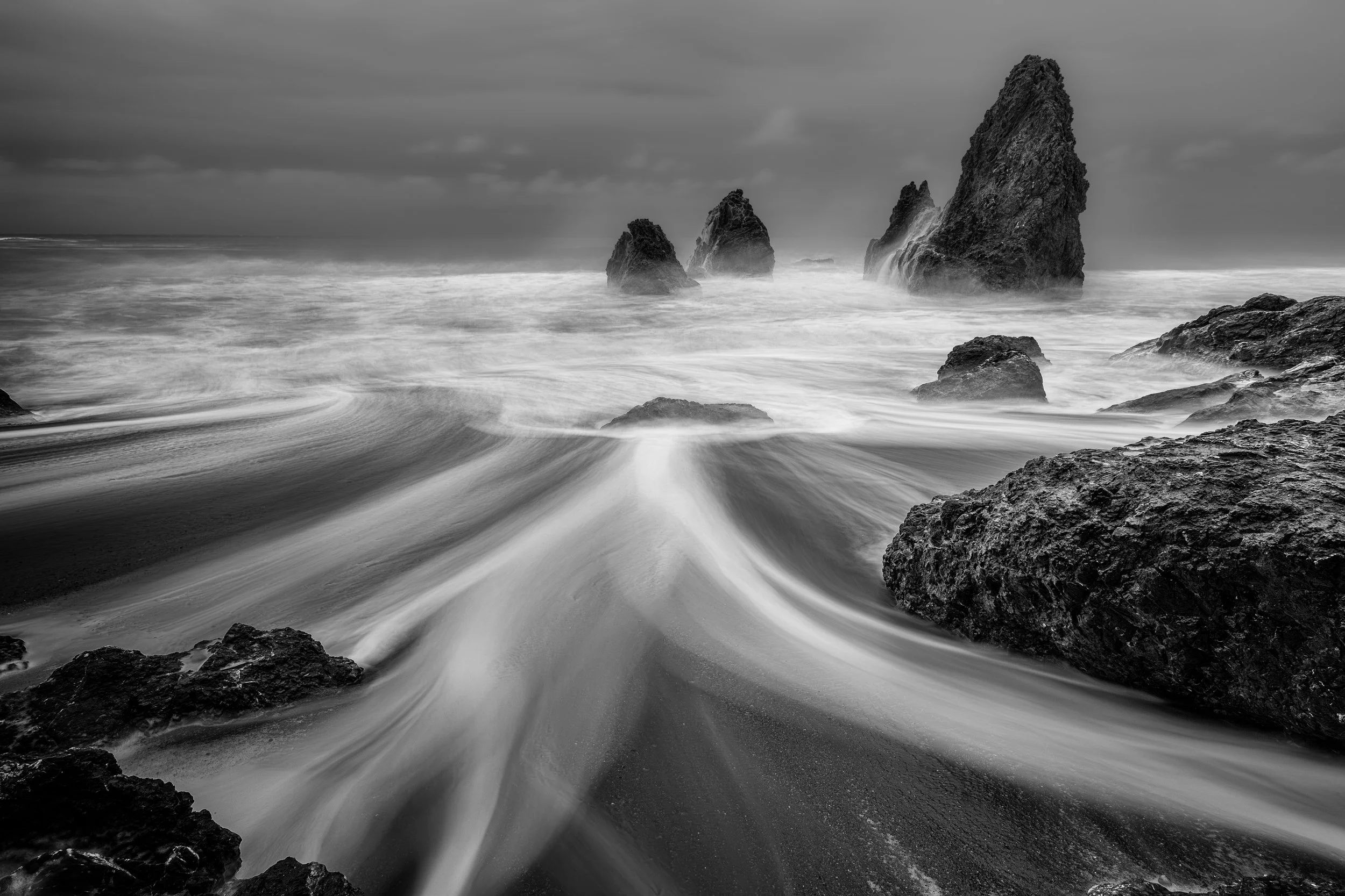 Tides of Stone

 

 Rodeo Beach sits in the Marin Headlands north of San Francisco. Offshore rocks, sea stacks, dark sand, and Pacific surf define this shoreline within Golden Gate National Recreation Area. 