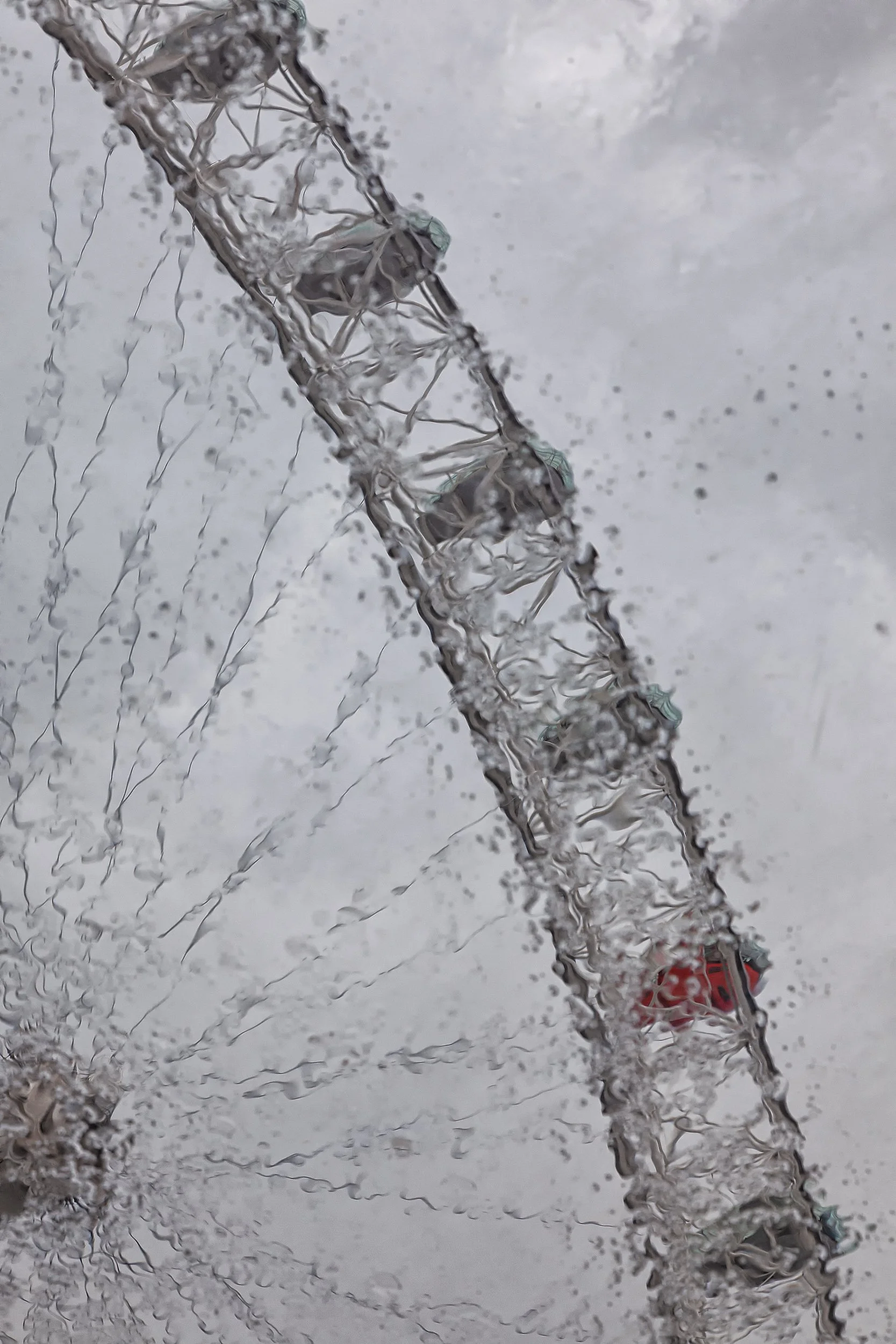 London Eye Through Rain Glass

 

  The London Eye stands on the South Bank of the River Thames in central London. Rain-covered glass and reflected light partially obscure the observation wheel in this urban detail. 