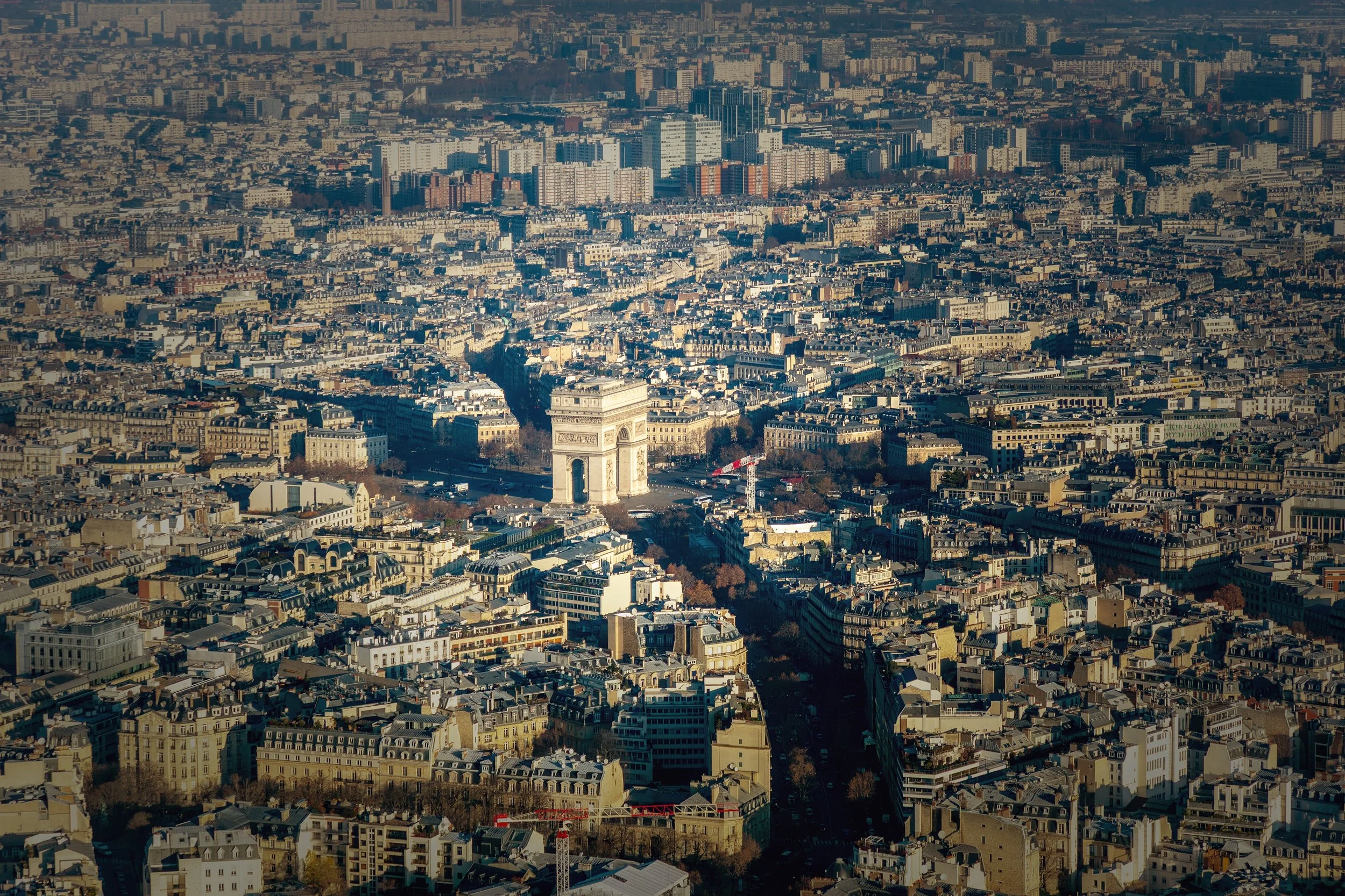 Arc de Triomphe from Above

 

 The Arc de Triomphe stands at Place Charles de Gaulle in Paris, at the western end of the Champs-Élysées. The monument anchors a major radial intersection surrounded by dense city blocks and avenues. 
