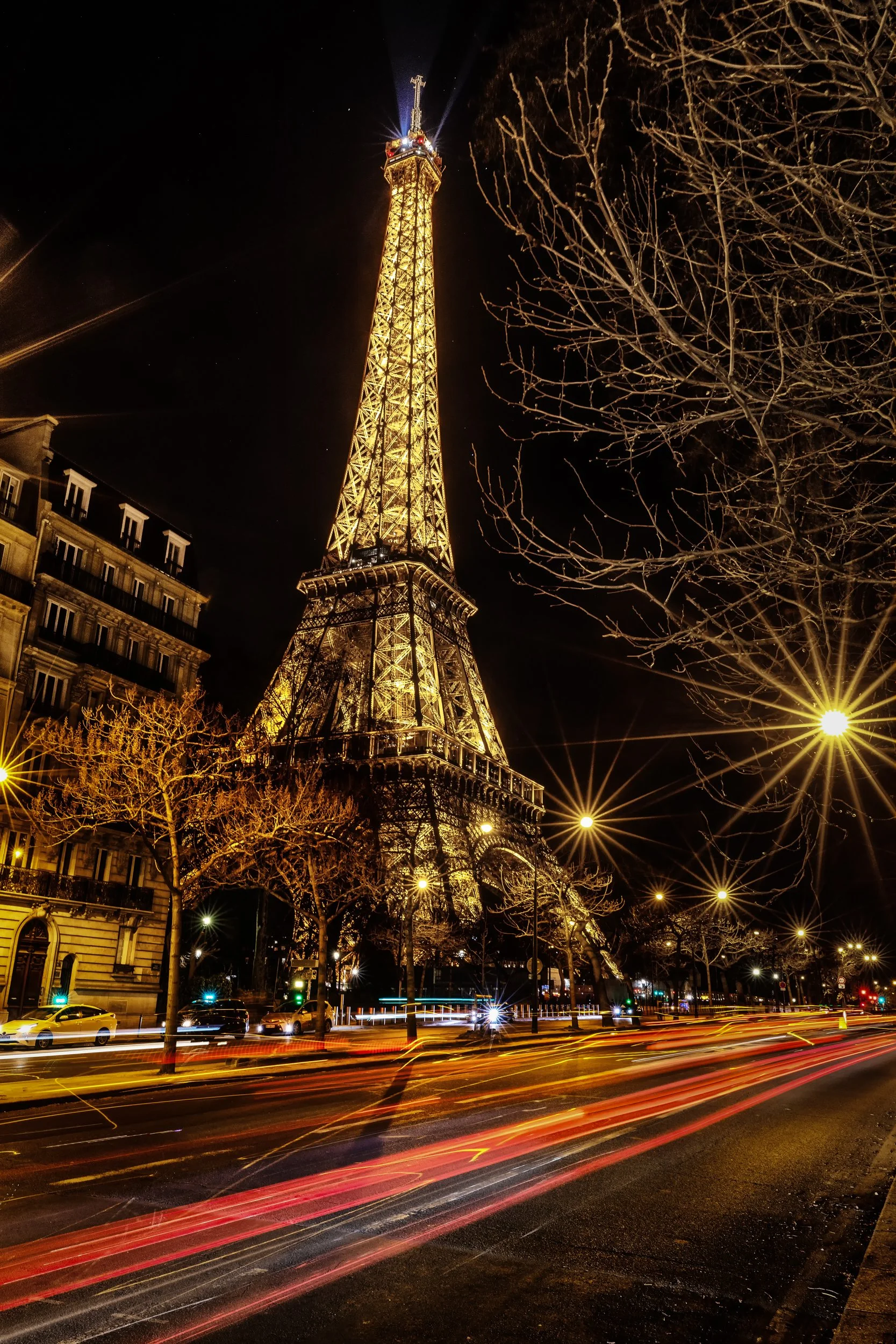 Eiffel Tower at Night

 

 The Eiffel Tower rises above Quai Jacques Chirac in Paris at night, with street lights and traffic trails along the riverside avenue. 