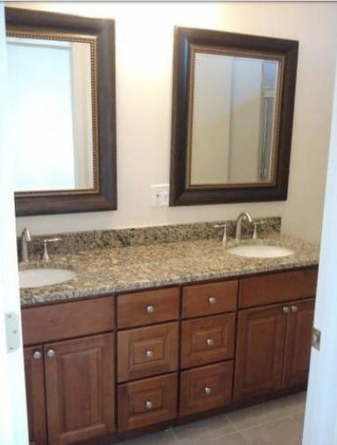 Each master bath features a double vanity. Planned renovations will bring an updated, modern look to the bathroom with new tile and updated vanities. 