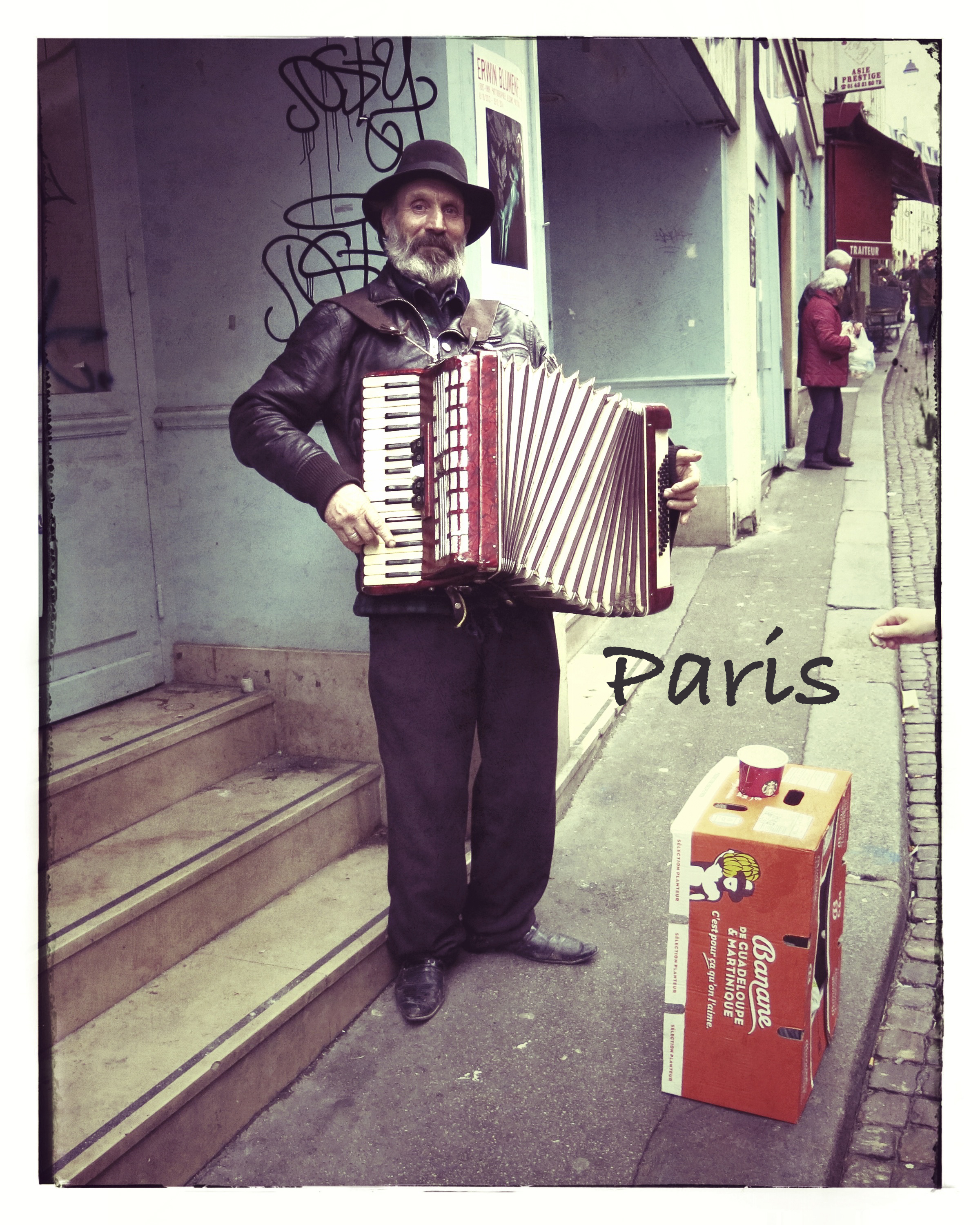 A man on a Paris street plays the Accordion.