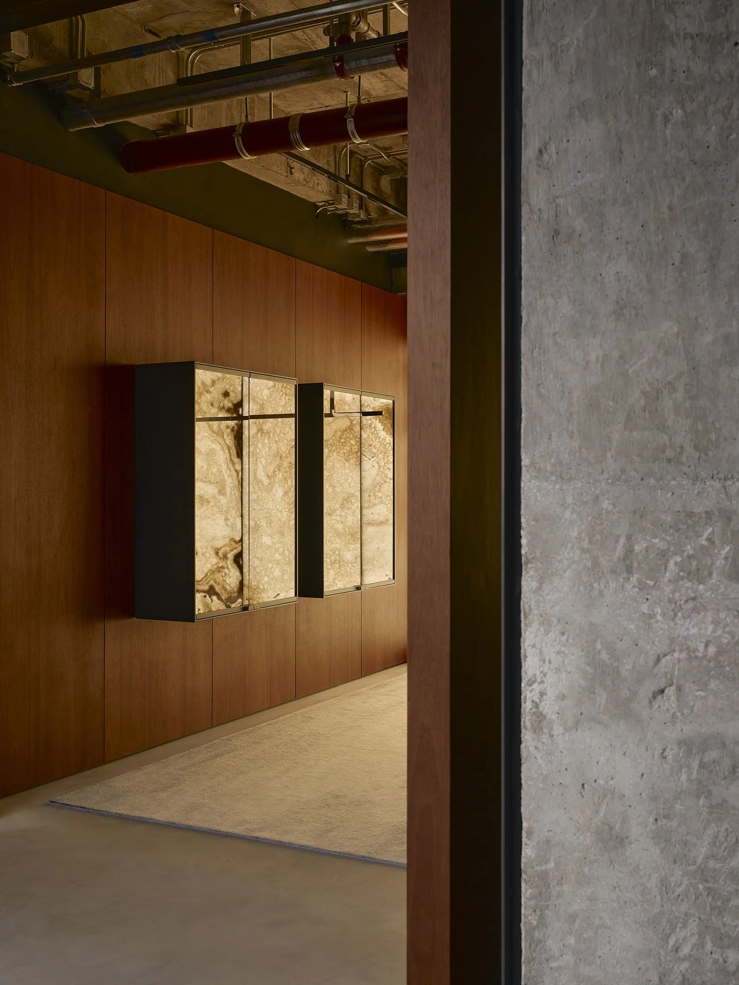 Saint Laurent flagship interior detail showing warm timber paneling and framed artwork