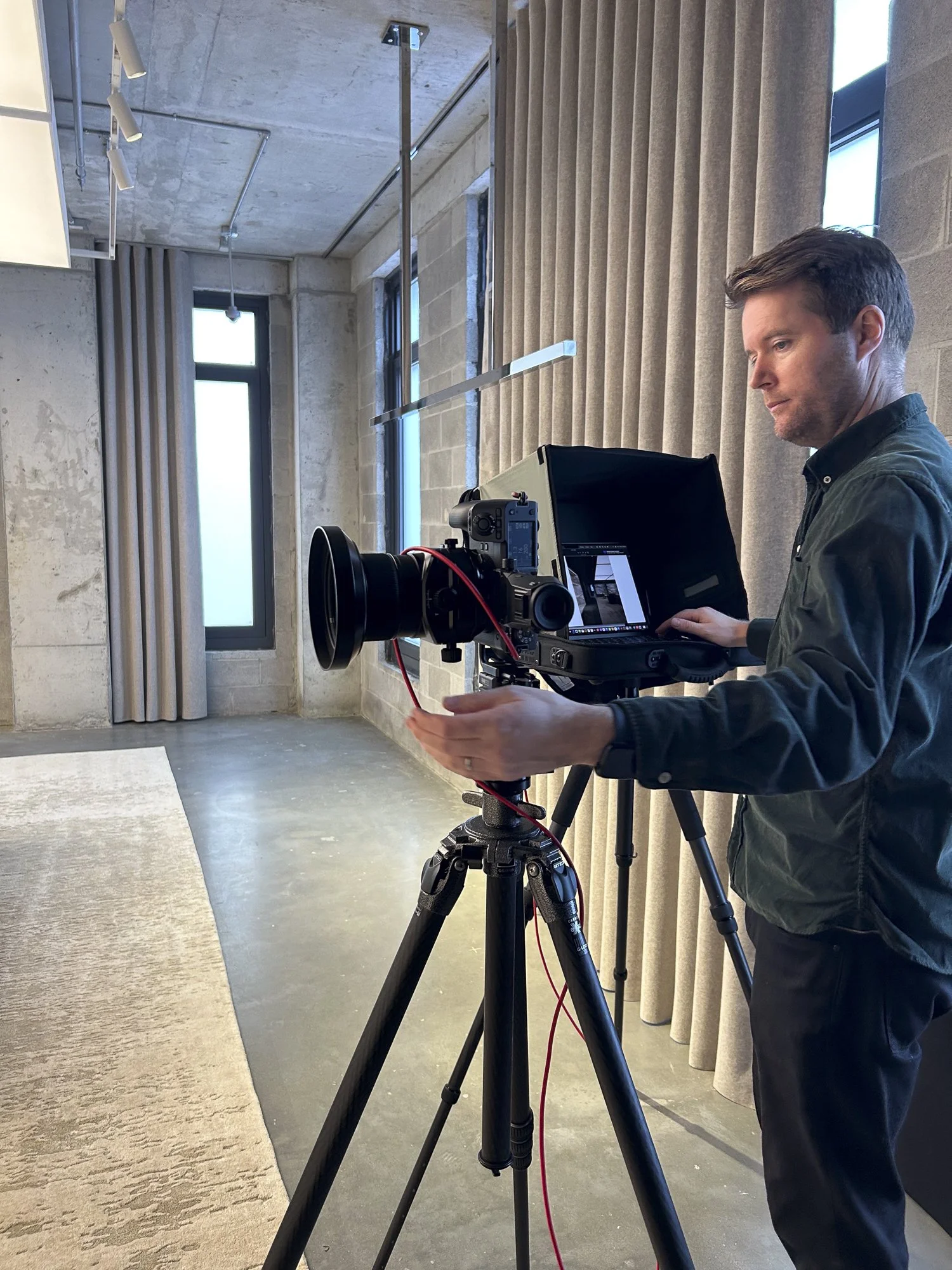 Commercial interior photographer Phillip Reed setting up a camera inside the Saint Laurent flagship store