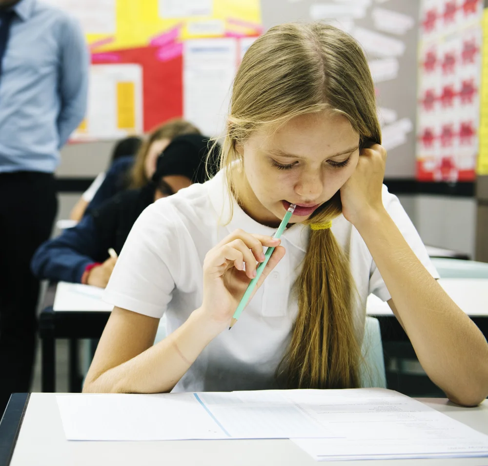 GIRL USING HER KNOWLEDGE gained FROM TUITION TO TO TAKE EXAM