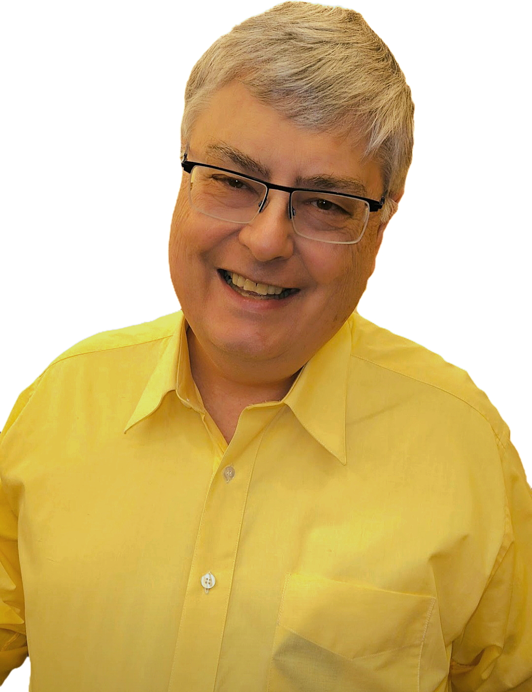 A man with gray hair and glasses smiling, wearing a yellow shirt.