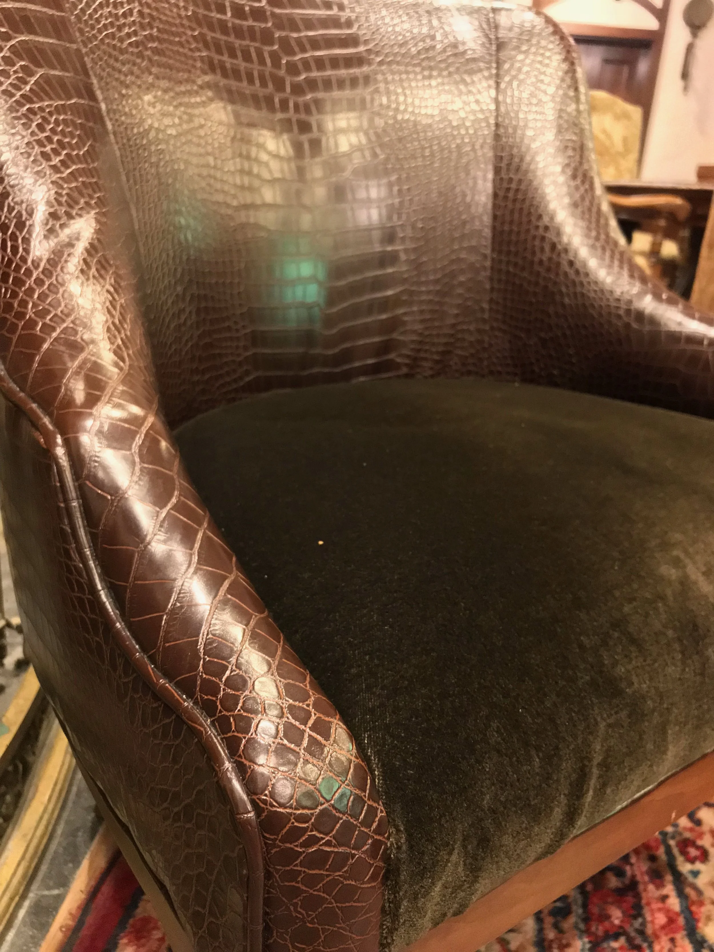 The tooled leather of the chairs inspired the box and the velour fabric was referenced with the red cloth that held the cards in the box.