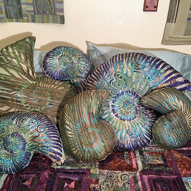 Lovely ammonite pillows. Hand painted and heavily machine quilted. Available at kimlacyfiberarts.etsy.com. #sofaart #bedart #decorativepillows #ammonitepillows #ammonites #ammoniteart #fossilart