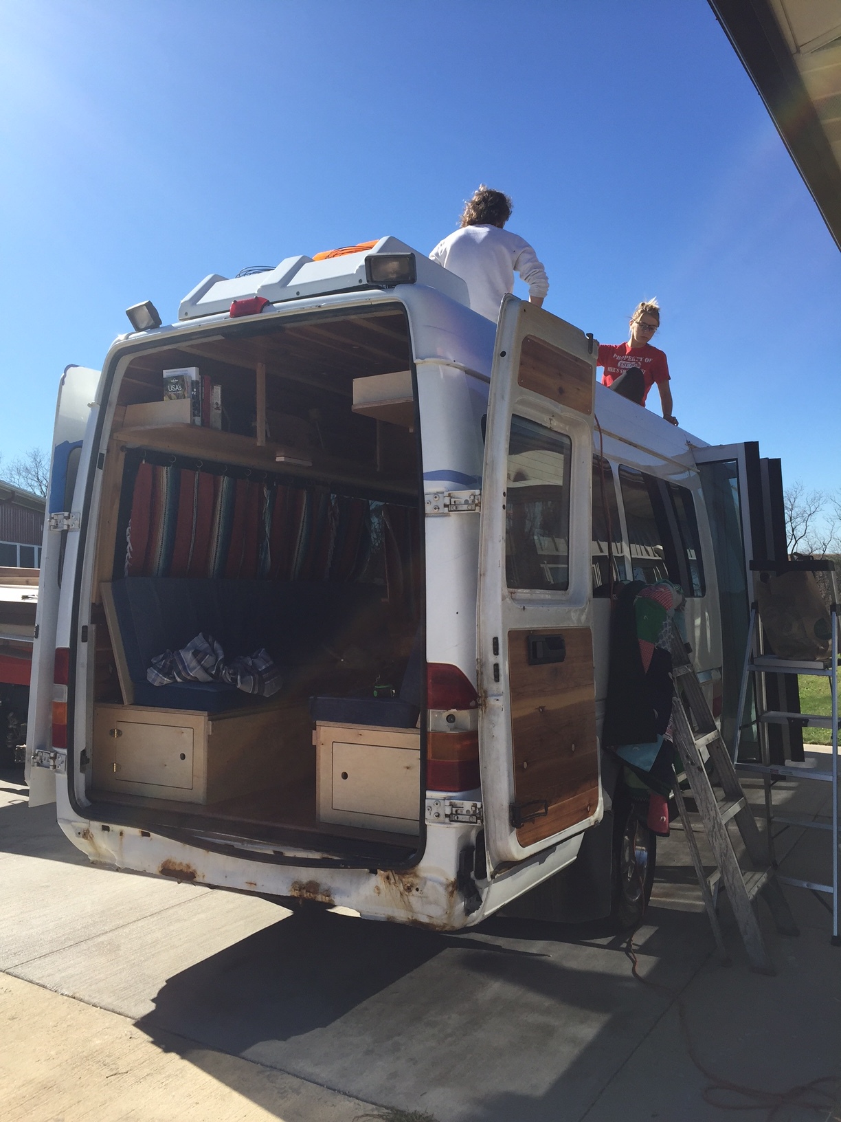 Installing our Renogy Solar panels on the van's roof.