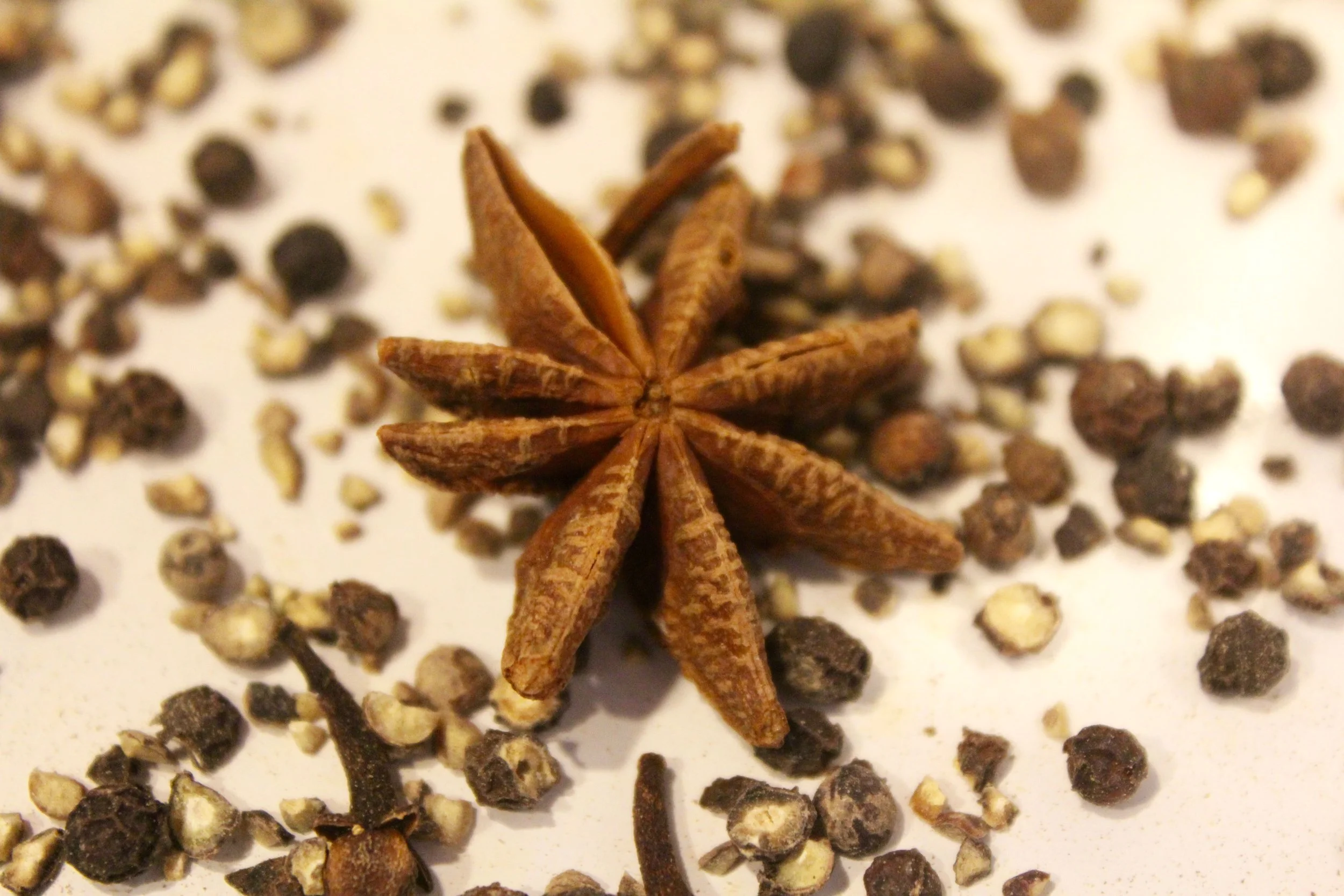 Toasting the star anise, cloves, and peppercorns for a spiced, autumnal start to a recipe.