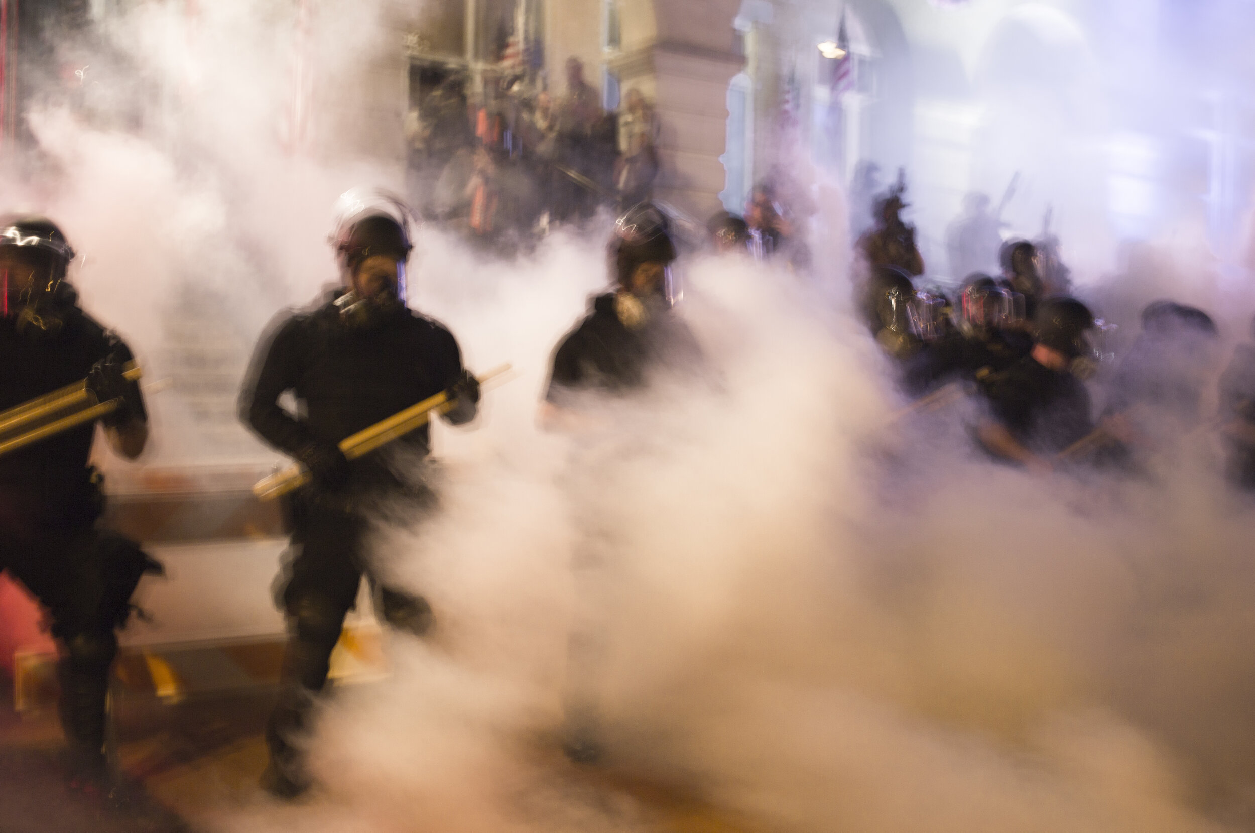  Tear gas fills the downtown Bentonville Square as Benton County Sheriff officers line the grounds of the Bentonville courthouse  