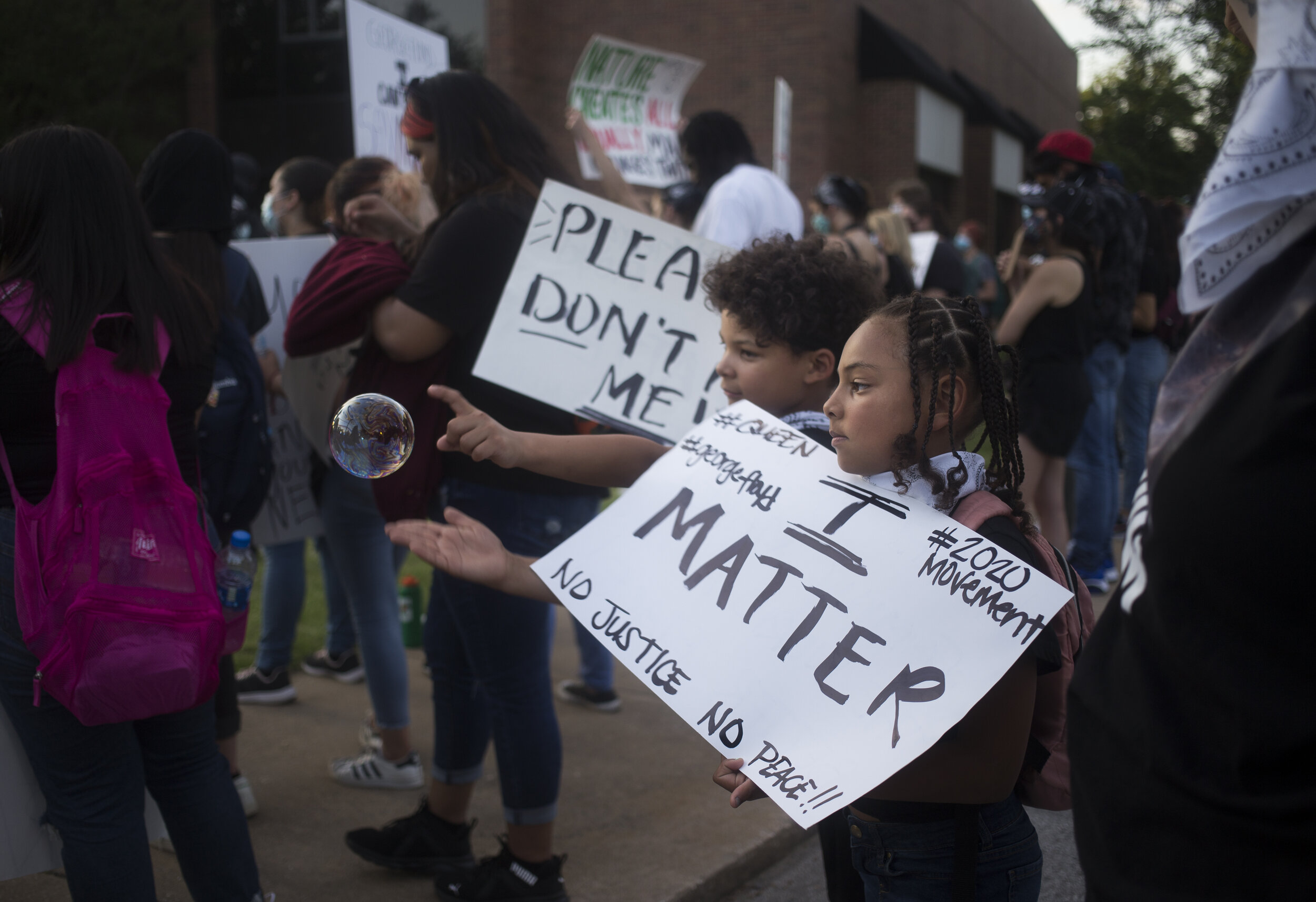  Dayon Malloy, 9, (from center left) and sister Lydia Malloy, 8, demonstrate during a protest against police brutality on the lawn of the Rogers City Hall in Rogers, Ark., Friday, June 5, 2020 