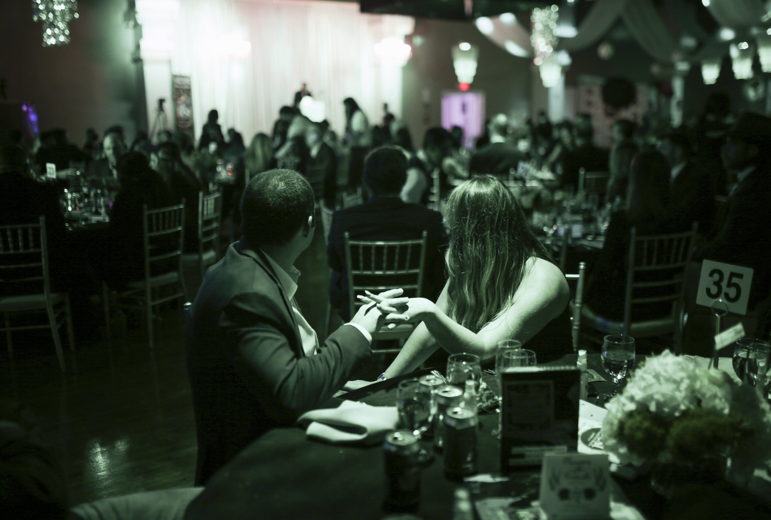  Attendees hold hands during the Best of Northwest Arkansas awards gala 