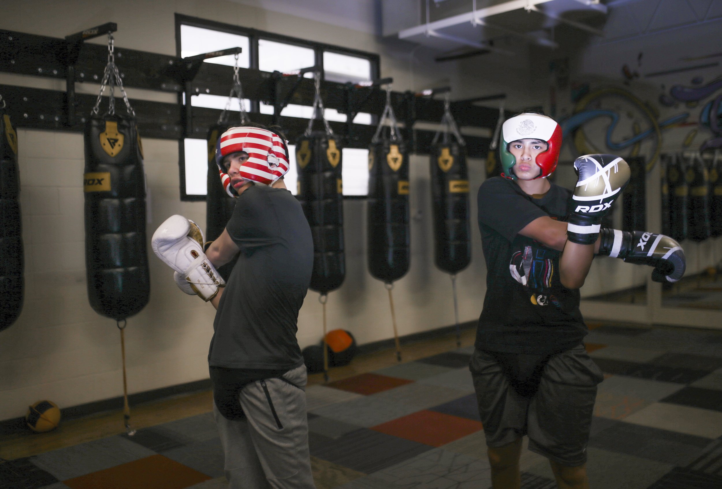  Joshua Jones, 17, (from left) and Ricardo "Gordo" Palos, 15, stretch before sparring at Straightright Boxing &amp; Fitness in Springdale, Saturday, April 17, 2021 