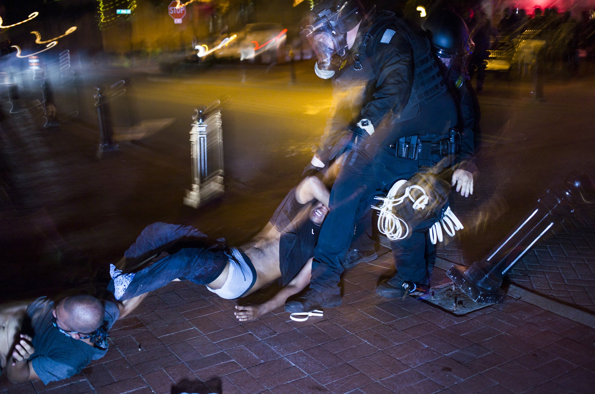  A Benton County Sheriff’s officer arrests a protestor after a dispersal order 