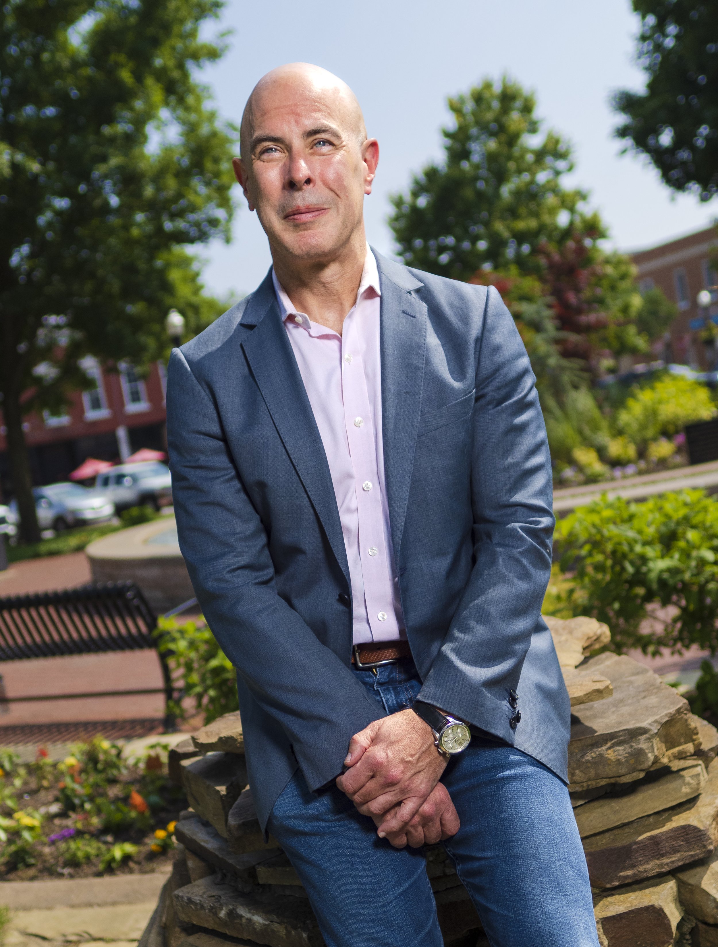 Robert Burns, director of the Home Region Group at the Walton Family Foundation, poses for a portrait at the downtown square in Bentonville, Monday, May 22, 2023.  