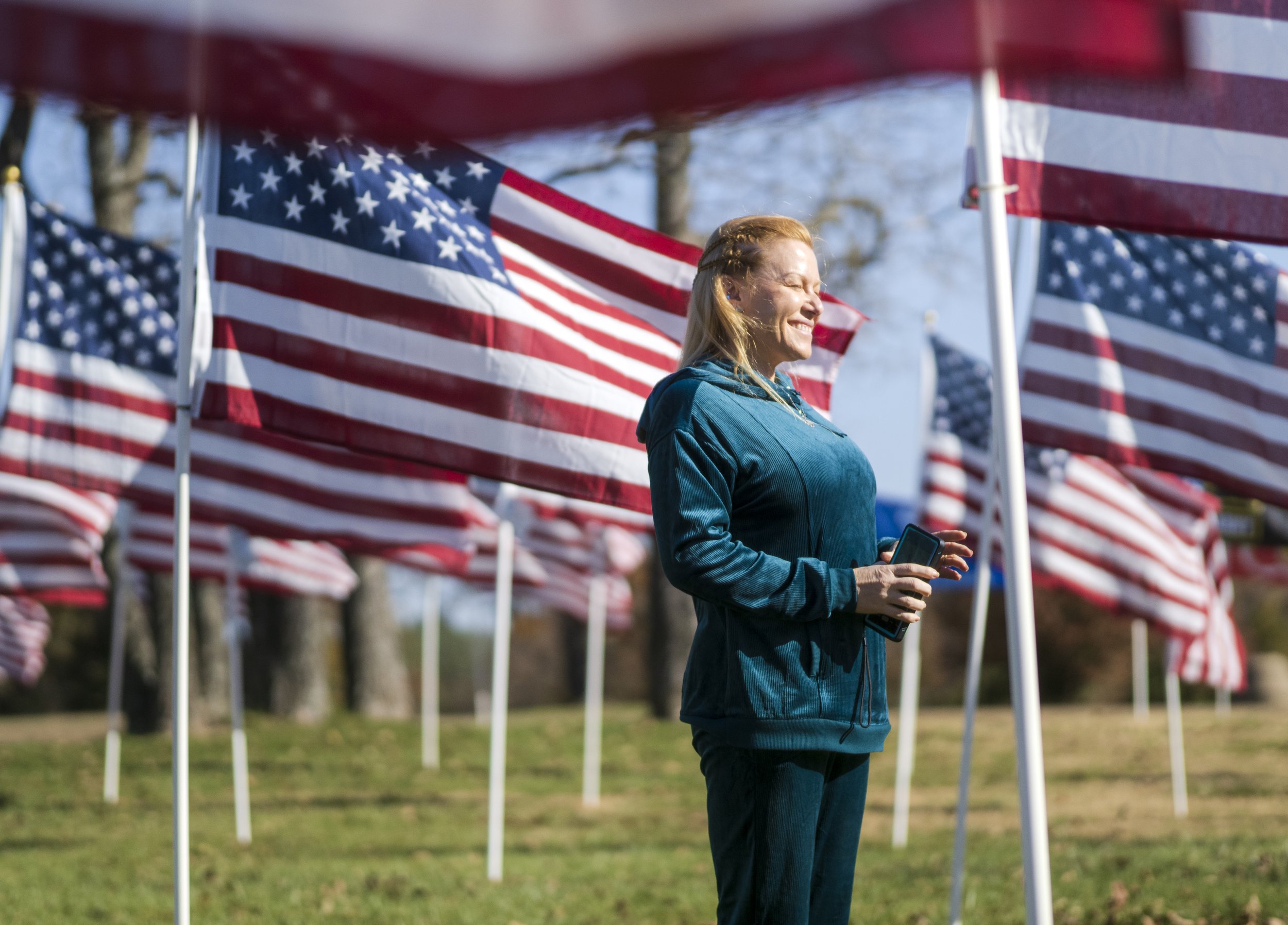  Kim Coker of Bella Vista observes flags at the Field of Honor on the lawn of the Catalyst Church in Bentonville, Friday, November 10, 2023. The Rotary Club of Bentonville hosted the community’s third Field of Honor, a display of 350 flags, each repr