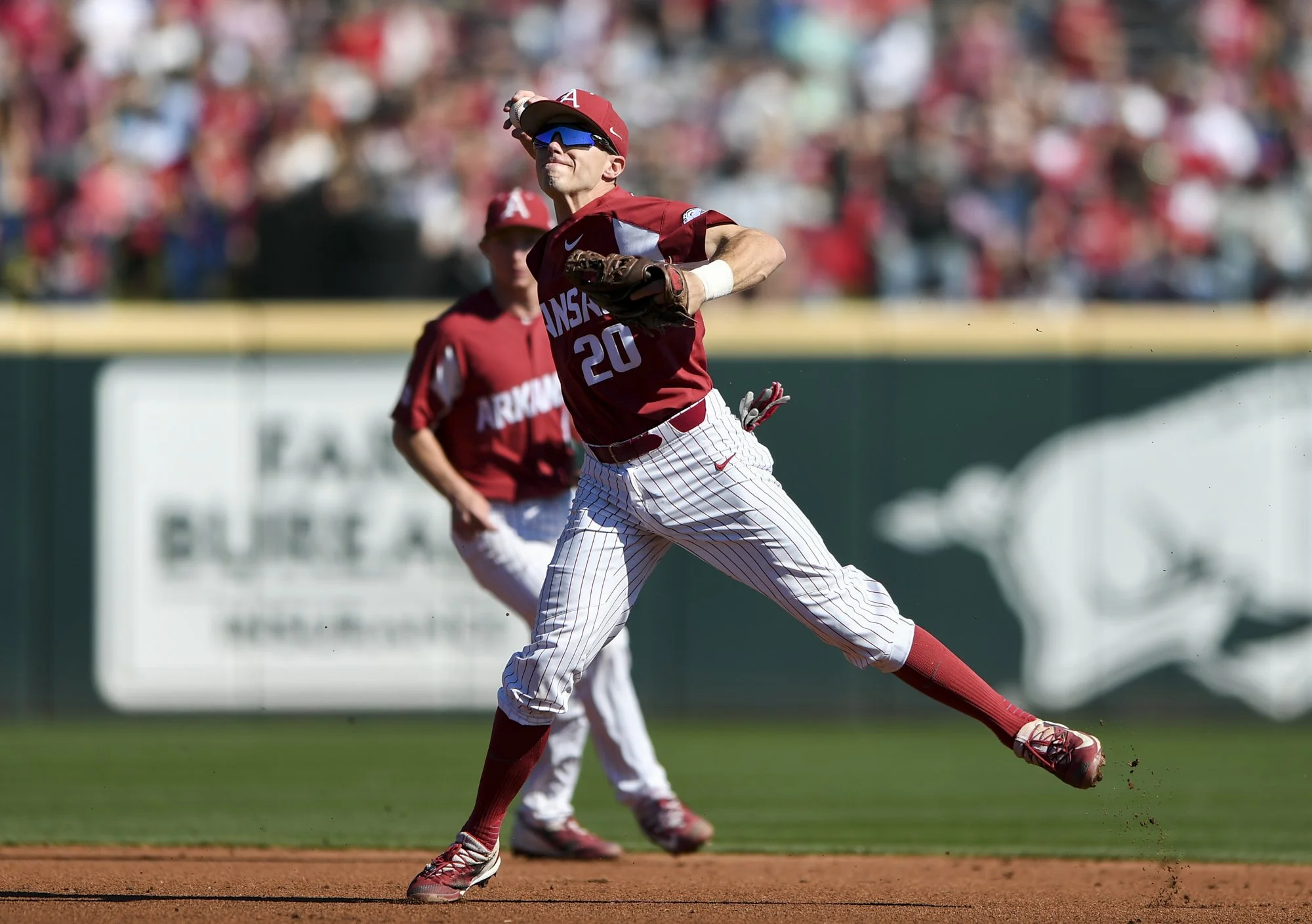 Arkansas infielder Carson Shaddy (20) throws the ball during a baseball game, Saturday, March 3, 2018 at Baum Stadium in Fayetteville.
