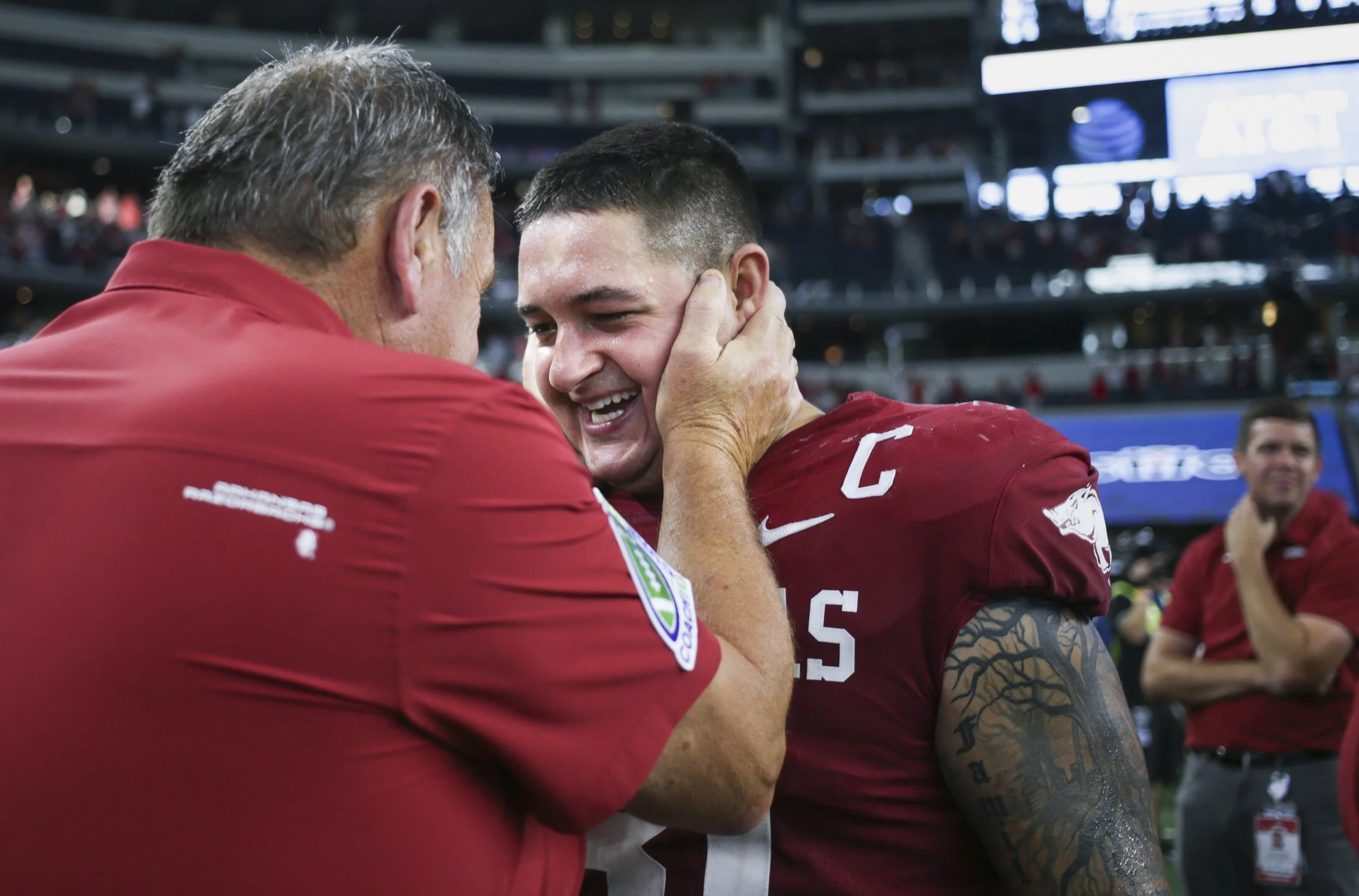 Arkansas head coach Sam Pittman congratulates Grant Morgan (31), Saturday, September 25, 2021 at the end of a football game at AT&T Stadium in Arlington, Texas.