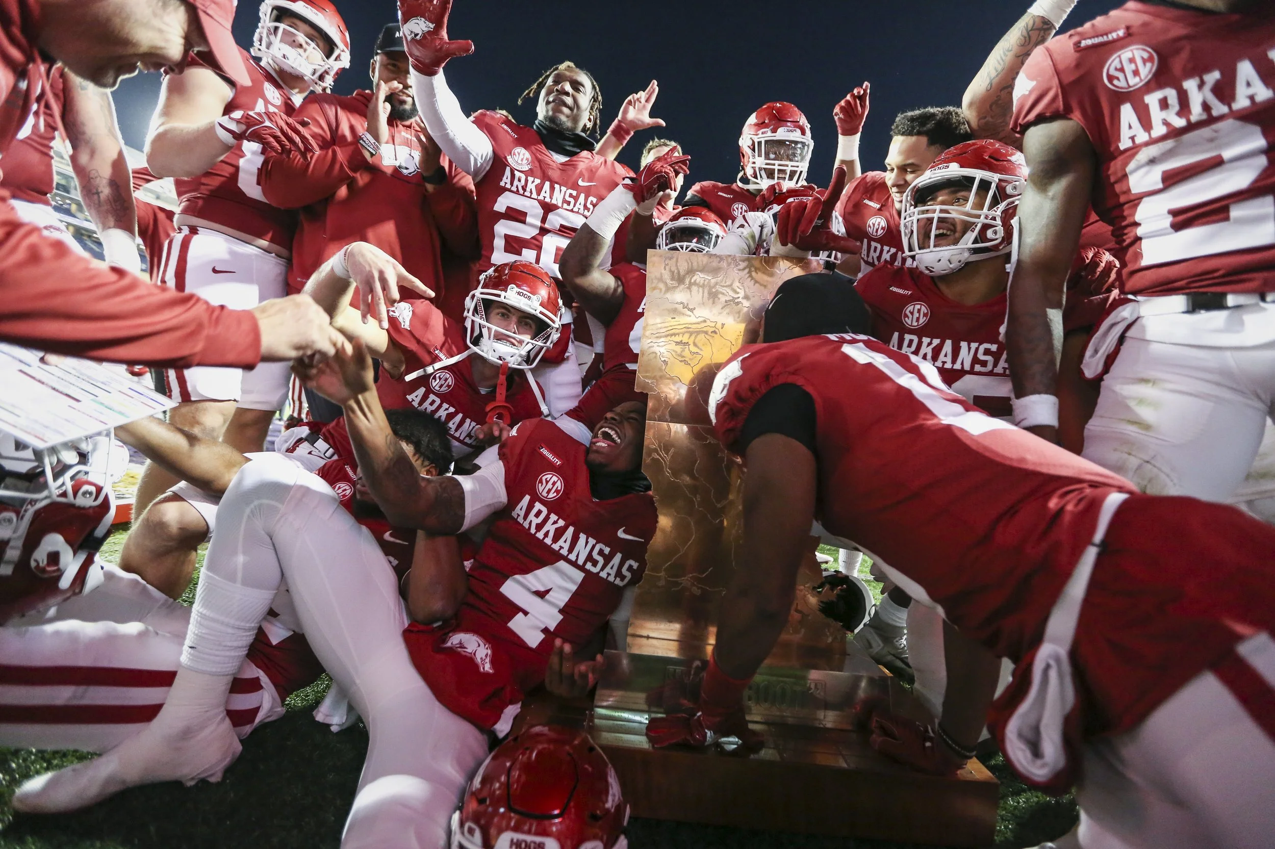 Arkansas players celebrate around the Boot Statue, Saturday, November 13, 2021 at the end of a football game at Tiger Stadium in Baton Rouge, La.