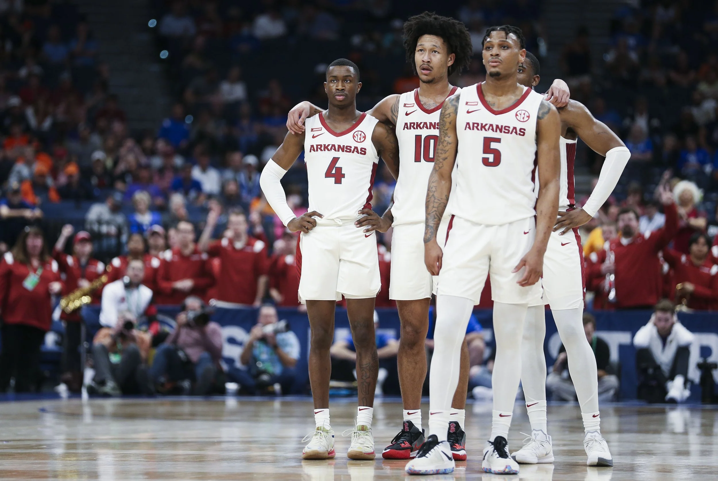 Arkansas players watch as guard Chris Lykes (11) (not pictured) shoots free throws, Friday, March 11, 2021 during the first half of Arkansas' 79-67 win against LSU at the SEC tournament quarterfinal at Amalie Arena in Tampa, Fla.