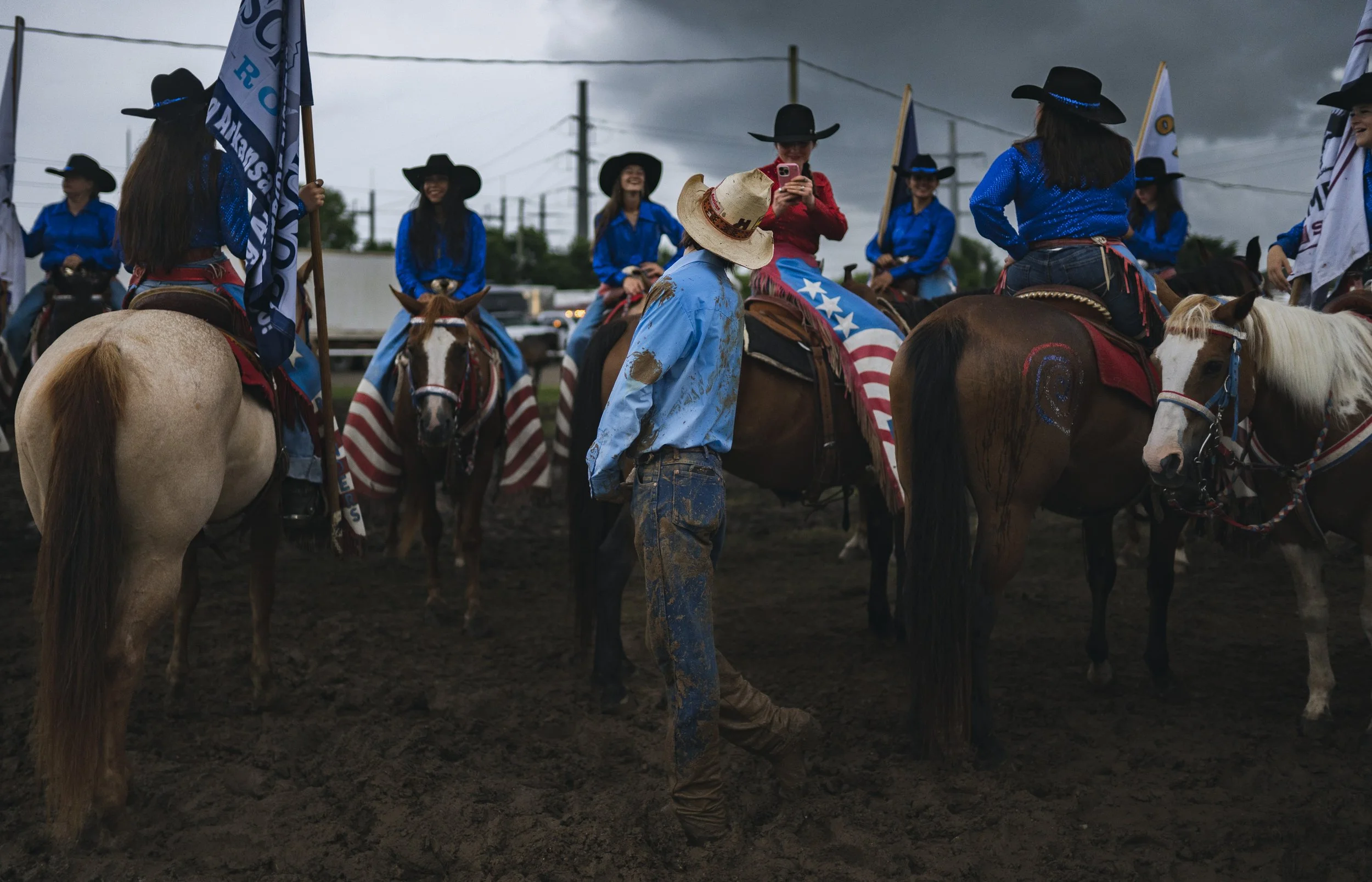 Rounders take pictures and visit while waiting for the start of the grand entry, Thursday, June 25, 2026 during the second night of the Rodeo of the Ozarks at Parsons Stadium in Springdale. The Rodeo of the Ozarks, now in its 82nd year, features hear
