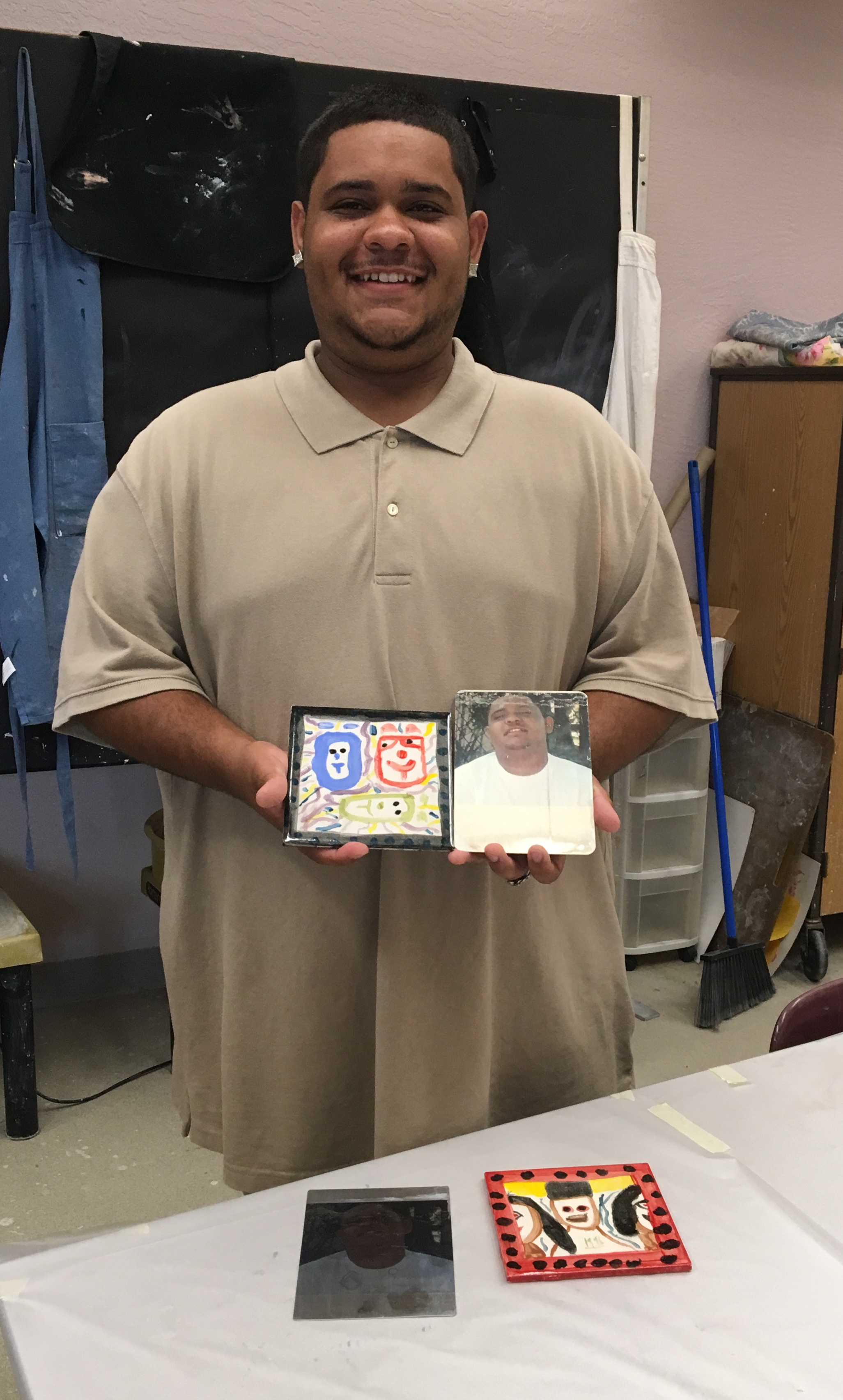 Student with selfie clay tile and metal transfer image.