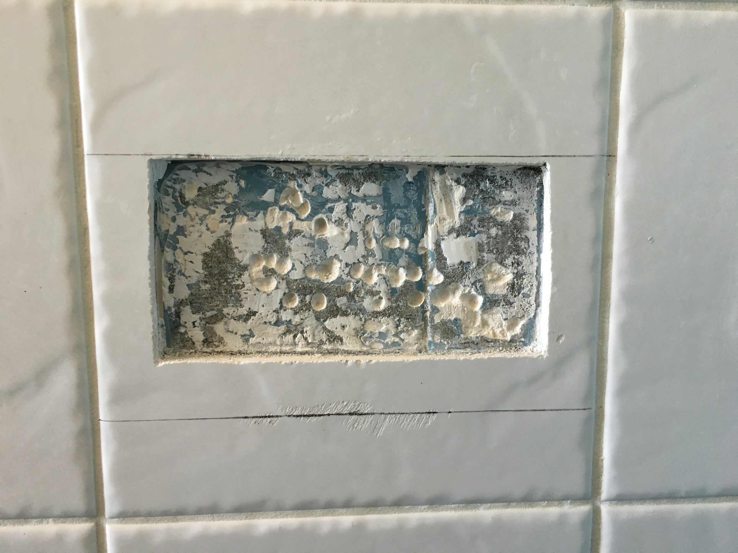 Soap dish removed and tile marked for cutting