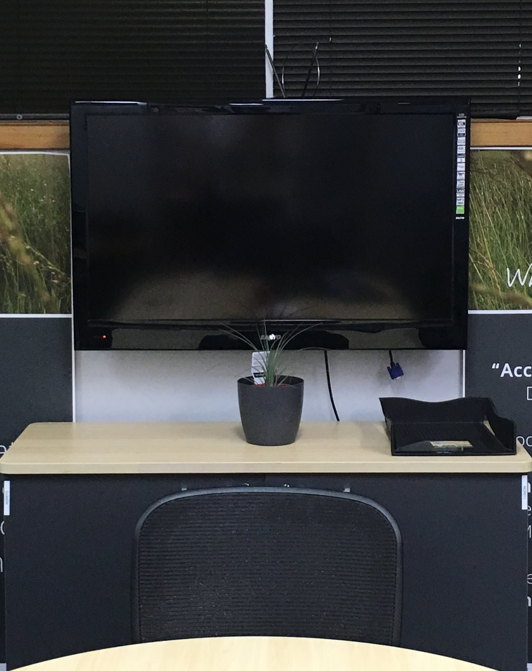 TV mounted to a plastered brick wall in the boardroom of a business in toowoomba