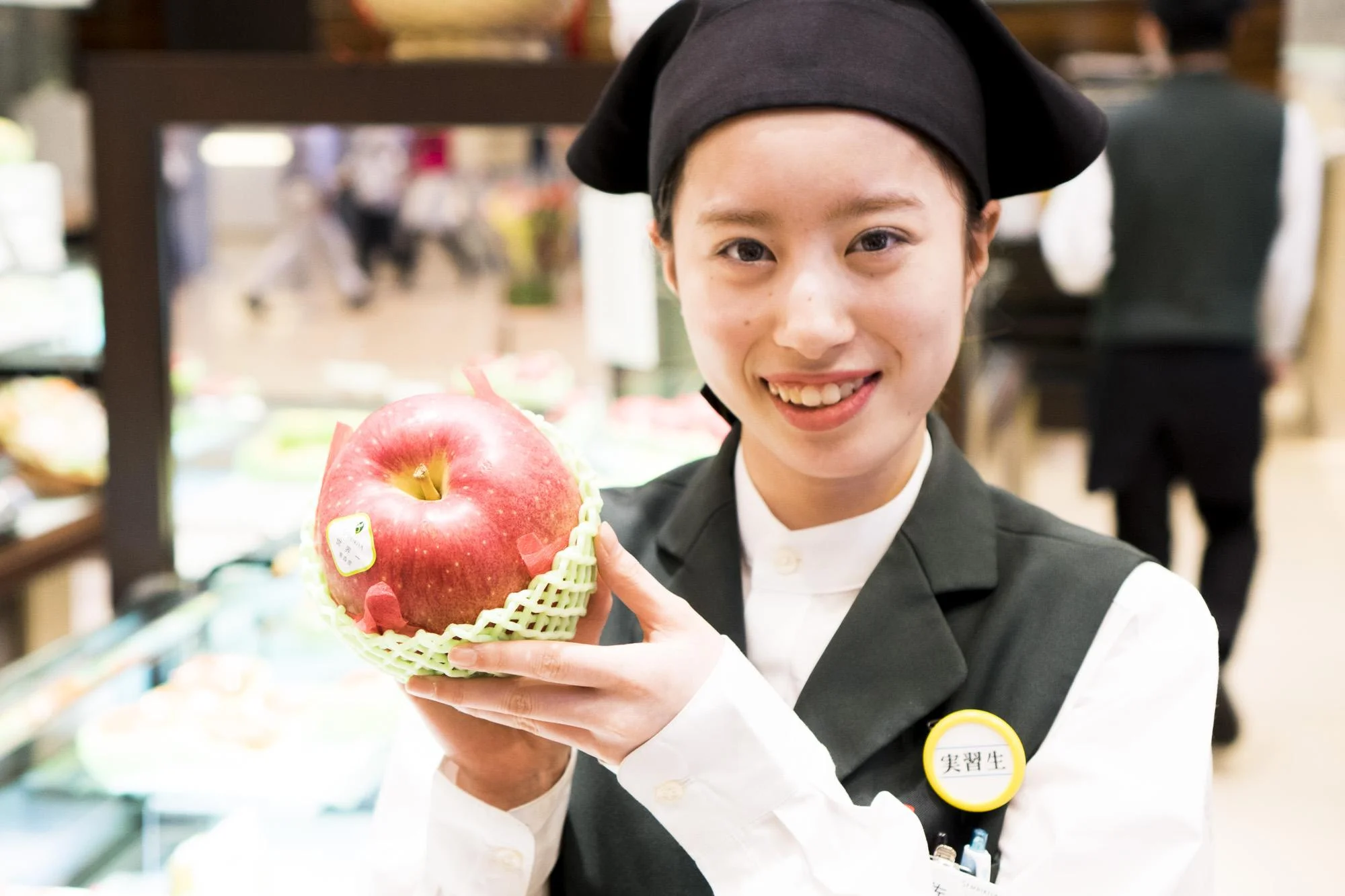 An attendant shows of a luxury apple at Sembikiya fruit boutique. From 'Why Should a Melon Cost as Much as a Car' by Bianca Boskey for Roads and Kingdoms. Photo by Alex Thomas