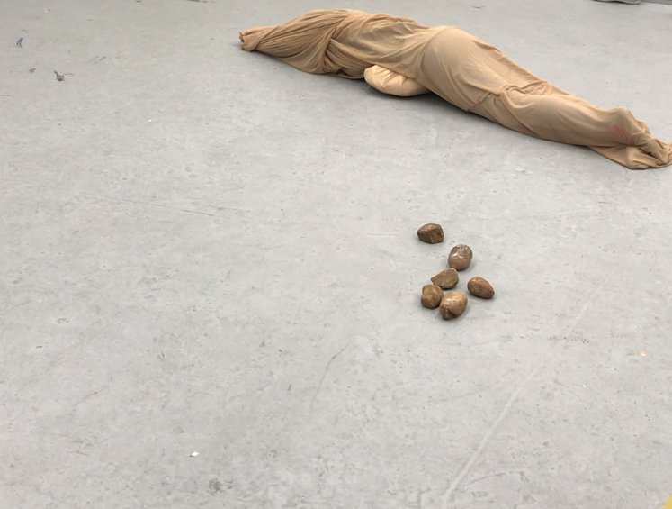 (ABOVE) SKINS and ROCKS performative installation/ experimentation 2019 creek-bed rocks, river rock, leather, bonded thread, textile, human body EARTHWORKS X WORLD WORKS FOR ALTERED GAZES collaboration with performance artist Holly Durant