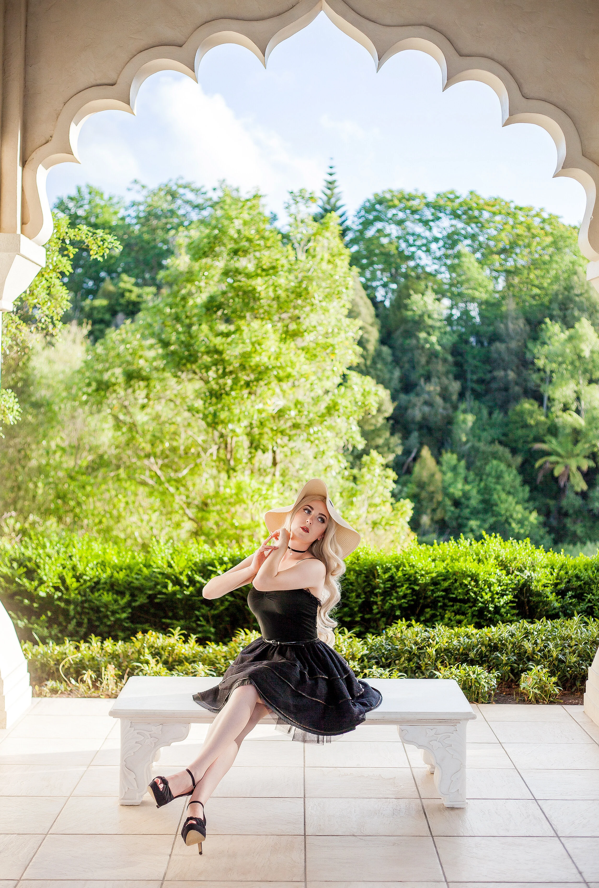 Above - Backlight from the sun outside creates a slight ‘angel halo’ around the subject’s outline. The subject’s face and body is in even light from the shelter this garden structure provides at the Hamilton Gardens.