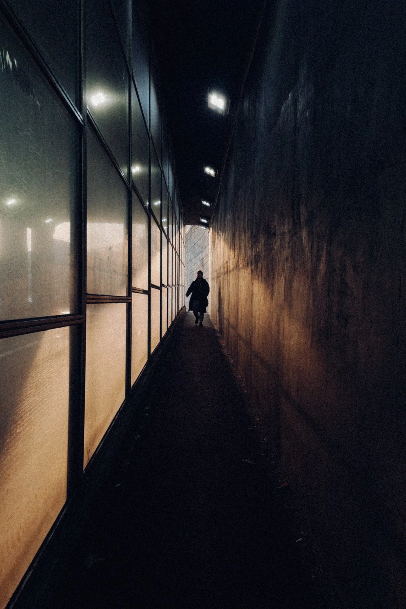 A woman walking through a bridge underpass in Seoul, South Korea.